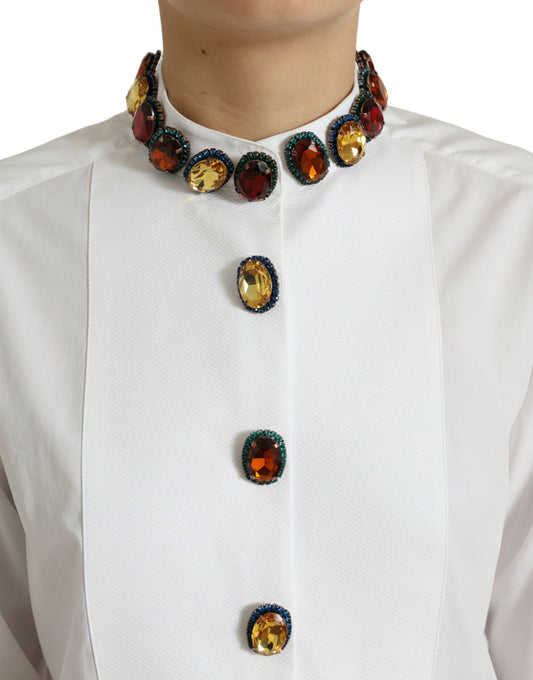 Woman wearing a white shirt with three large jewels on the front