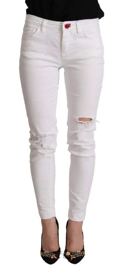 Pair of white skinny jeans with distressed knees