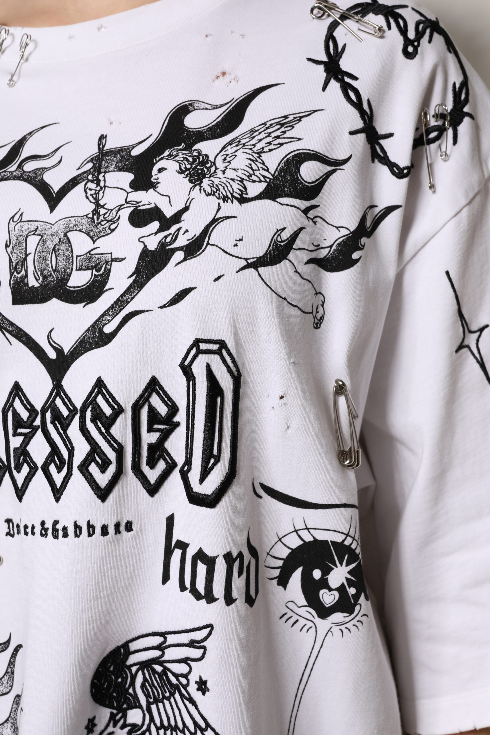 White graphic t-shirt with black lettering and design elements