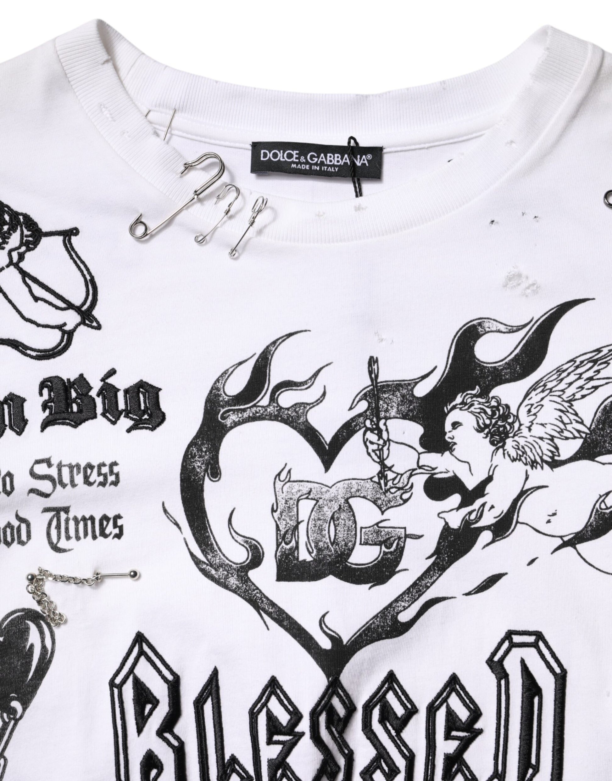 White sweater with black graphic design featuring a heart and wings
