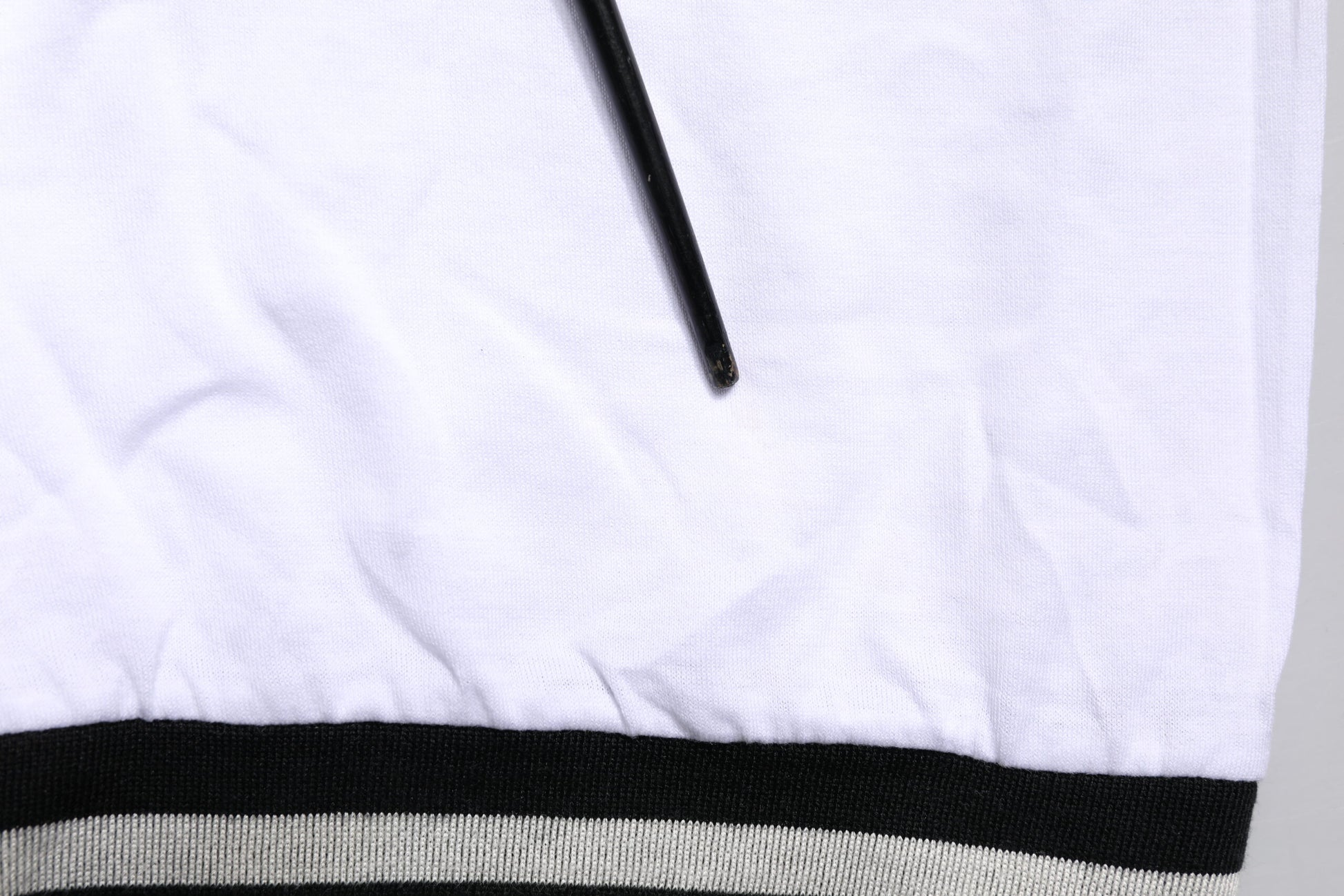 White towel with black stripe on edge