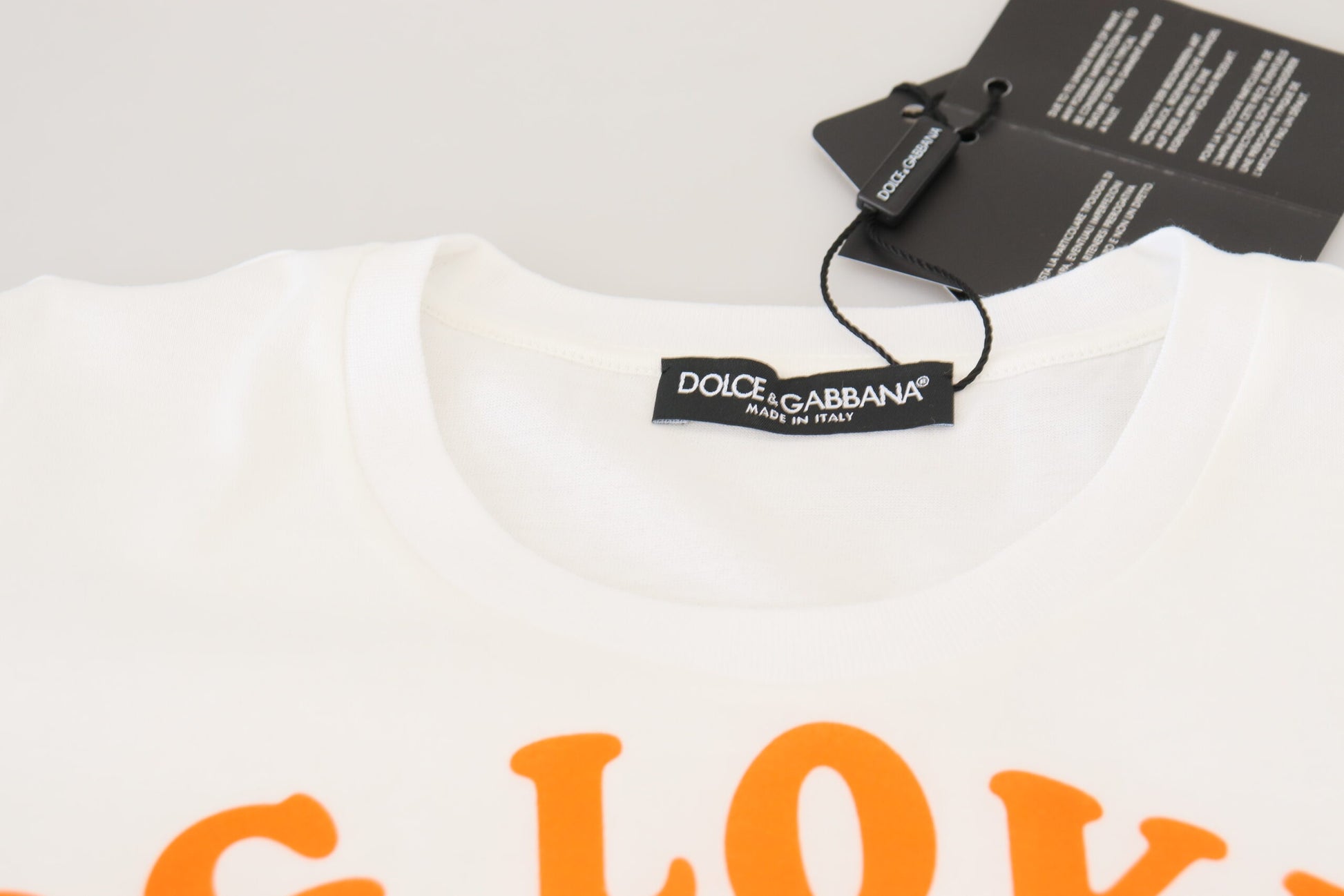 White t-shirt with orange text on front