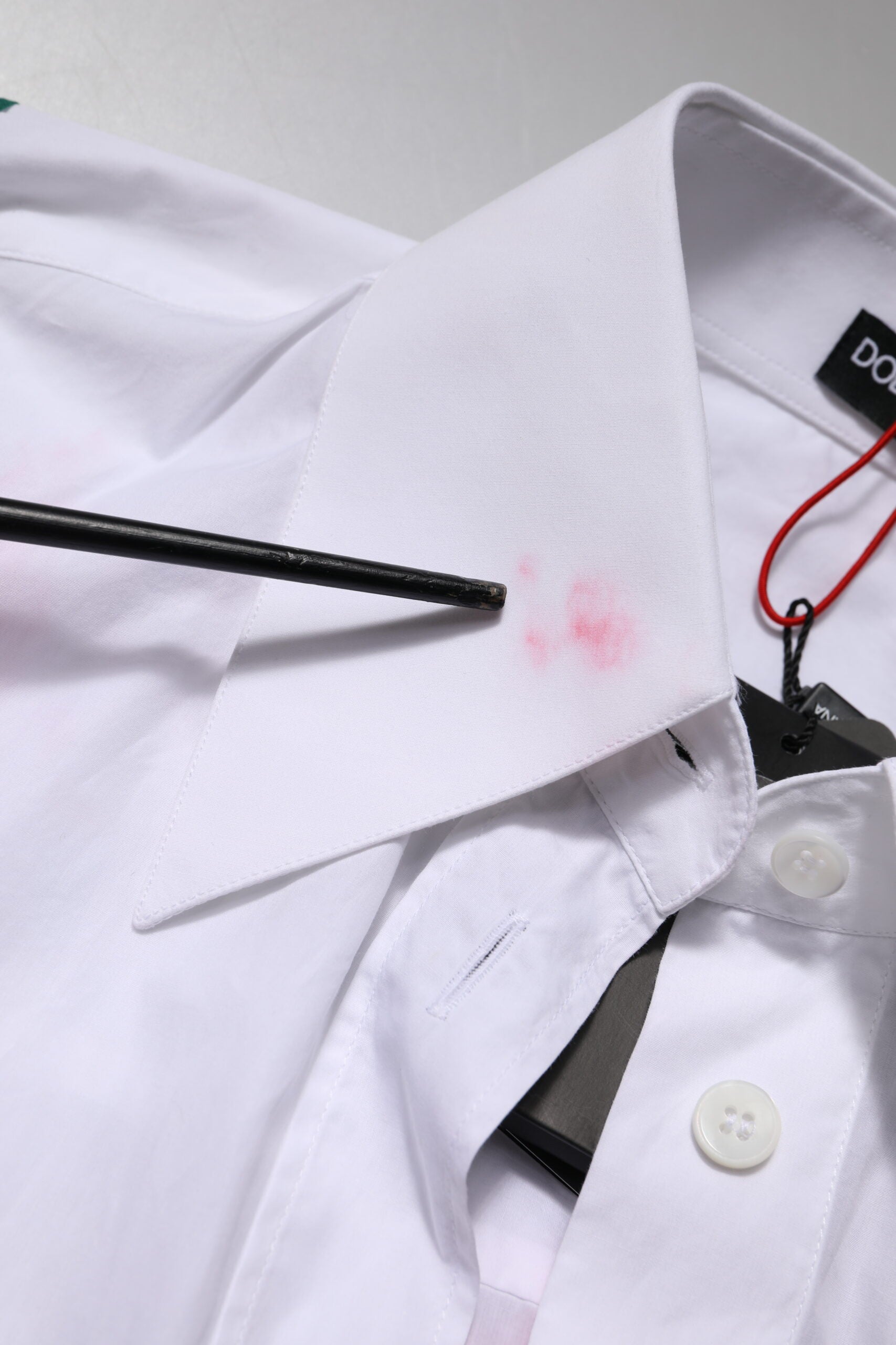 A white cotton dress shirt with floral applique details