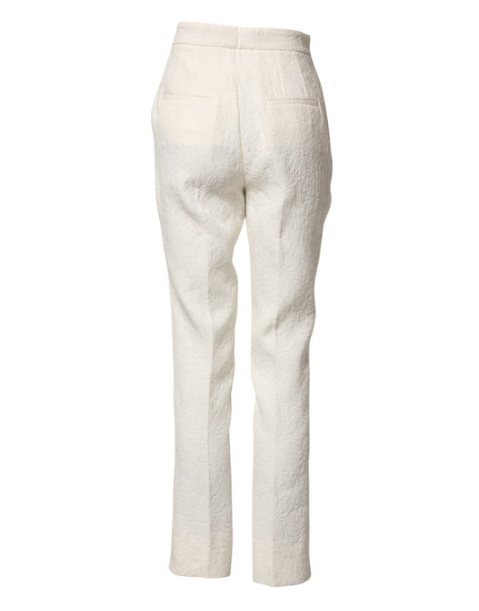 A pair of white cotton floral brocade dress pants by Dolce & Gabbana