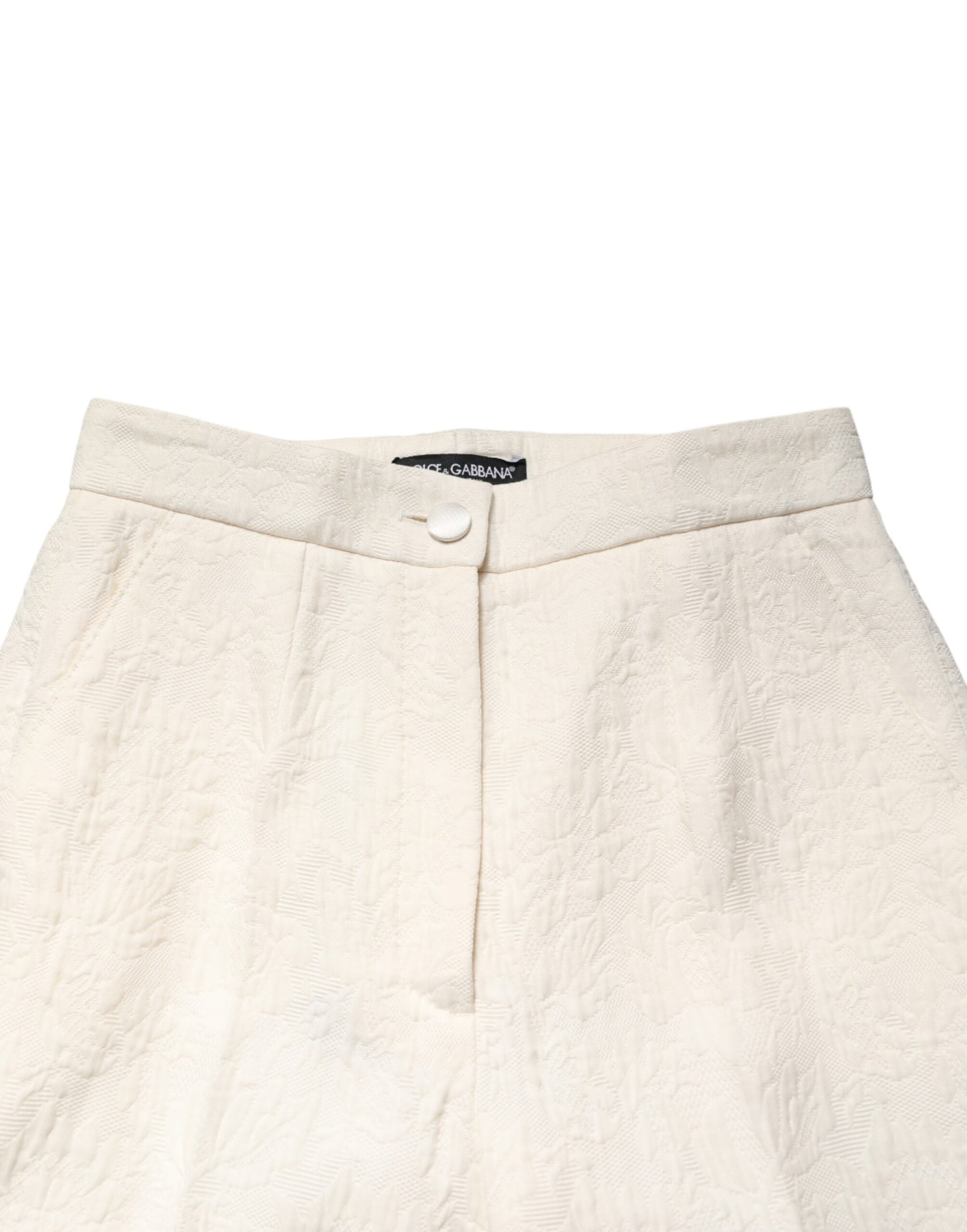 A pair of white cotton floral brocade dress pants by Dolce & Gabbana