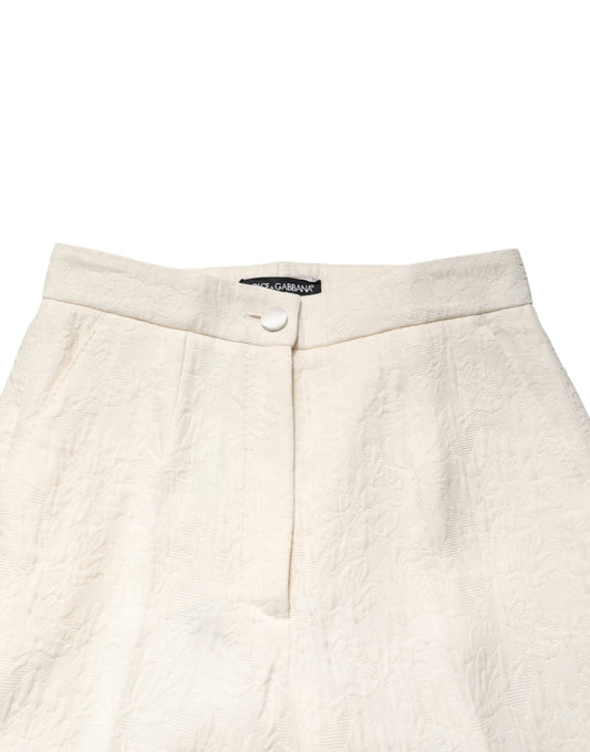 A pair of white cotton floral brocade dress pants by Dolce & Gabbana