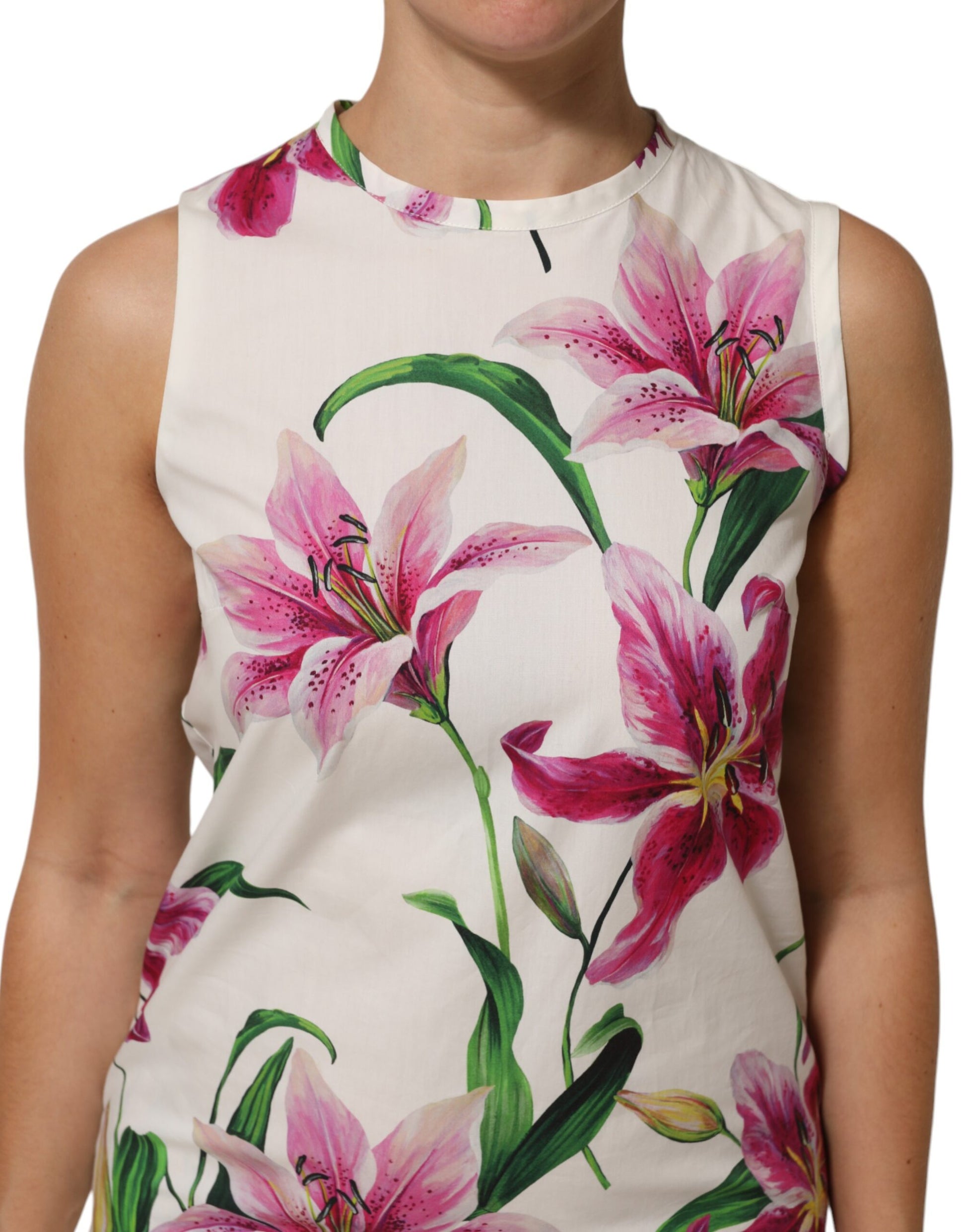 A sleeveless white cotton dress with a floral pattern featuring pink and green flowers