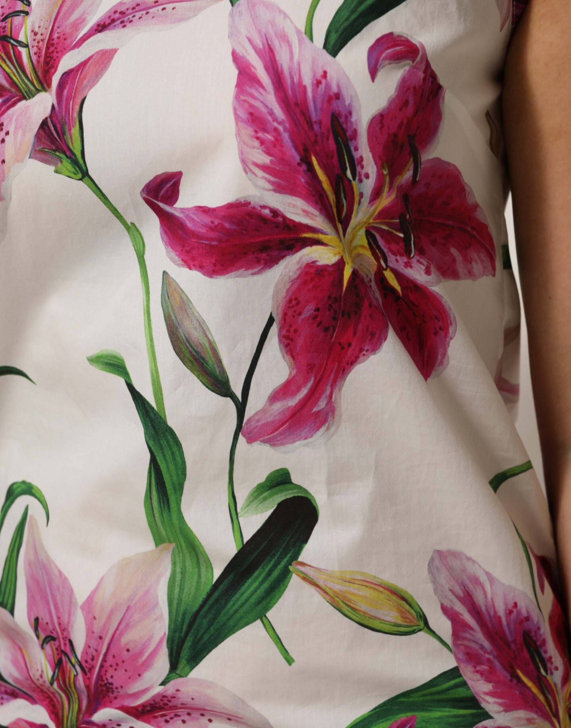 A sleeveless mini dress with a floral print featuring pink and white flowers