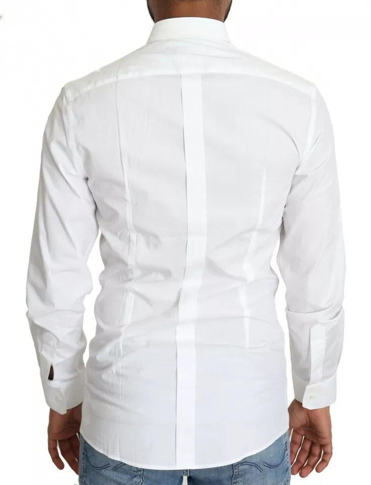 White cotton formal dress top with gold accents, long sleeves, and a collar