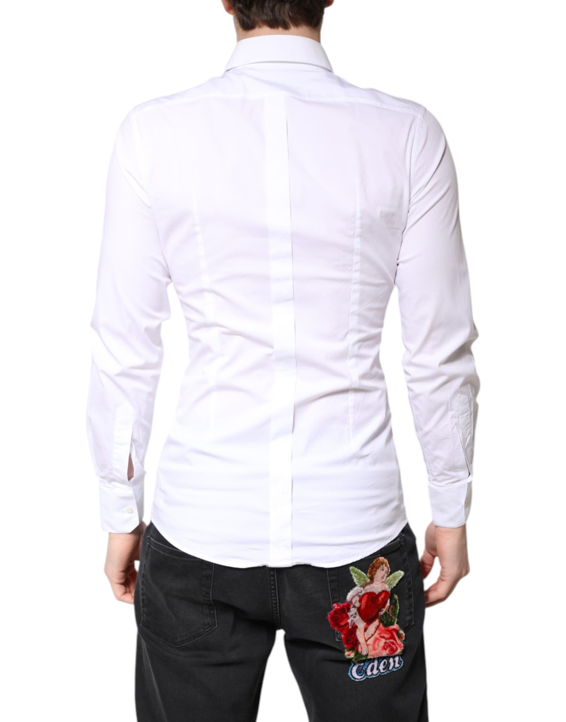 A white cotton collared shirt with gold detailing, featuring a floral embroidered patch on the back