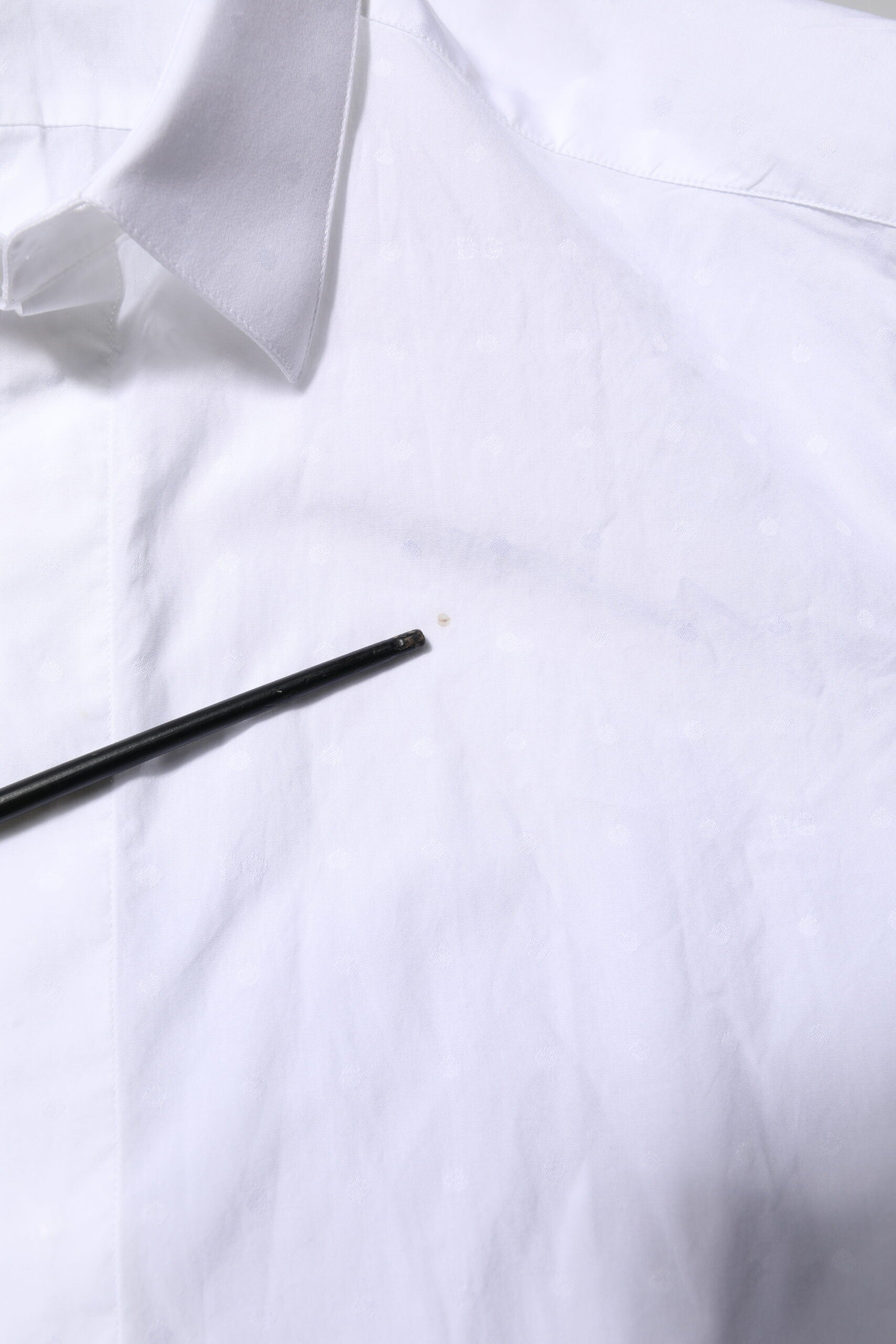 A white cotton dress shirt with a gold collar and cuffs