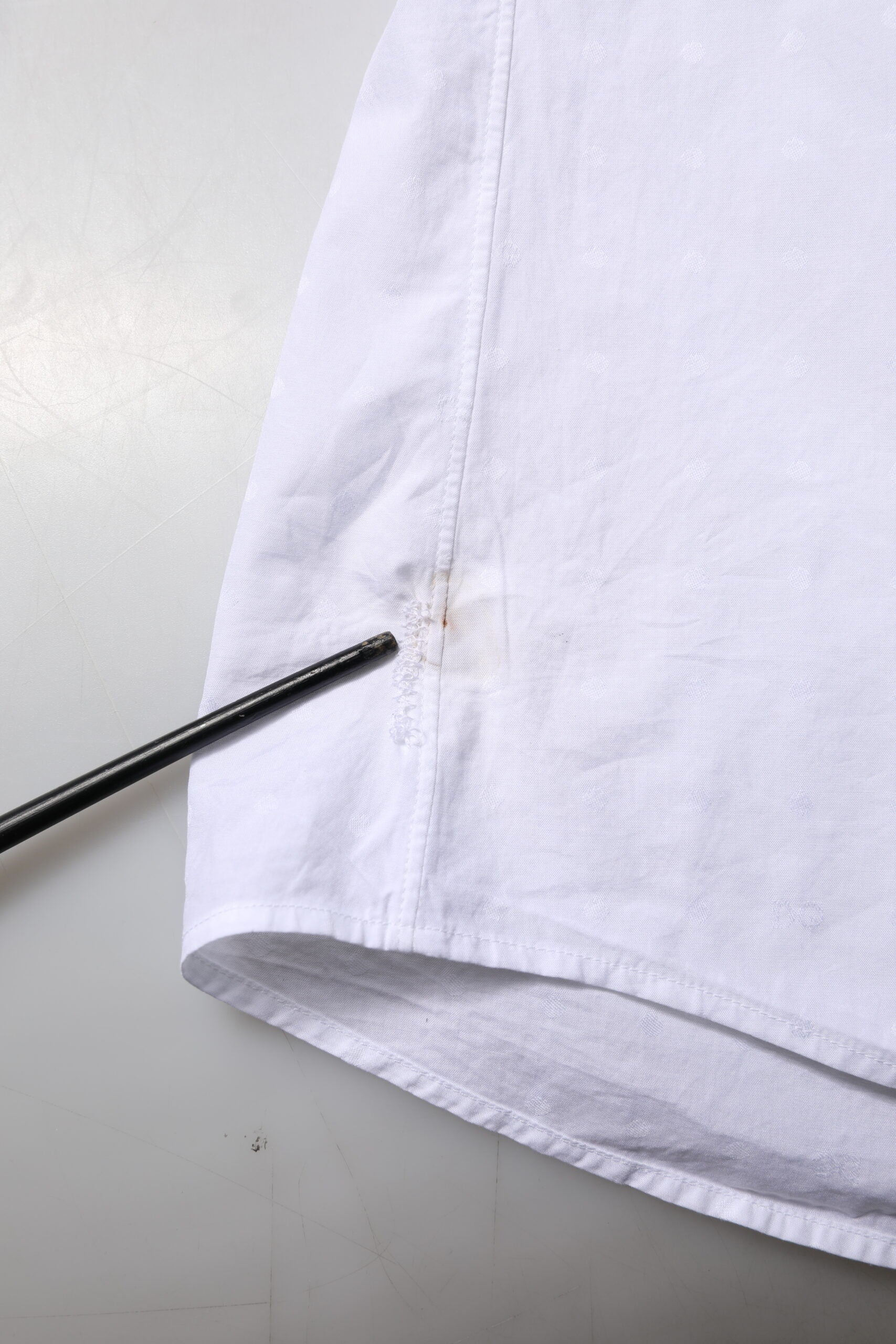 A white cotton dress shirt with a gold design, part of the formal wear collection by Dolce & Gabbana