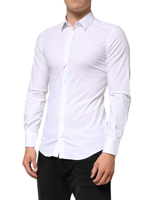 A white cotton dress shirt with long sleeves, designed by Dolce & Gabbana. It features a gold accent on the c
