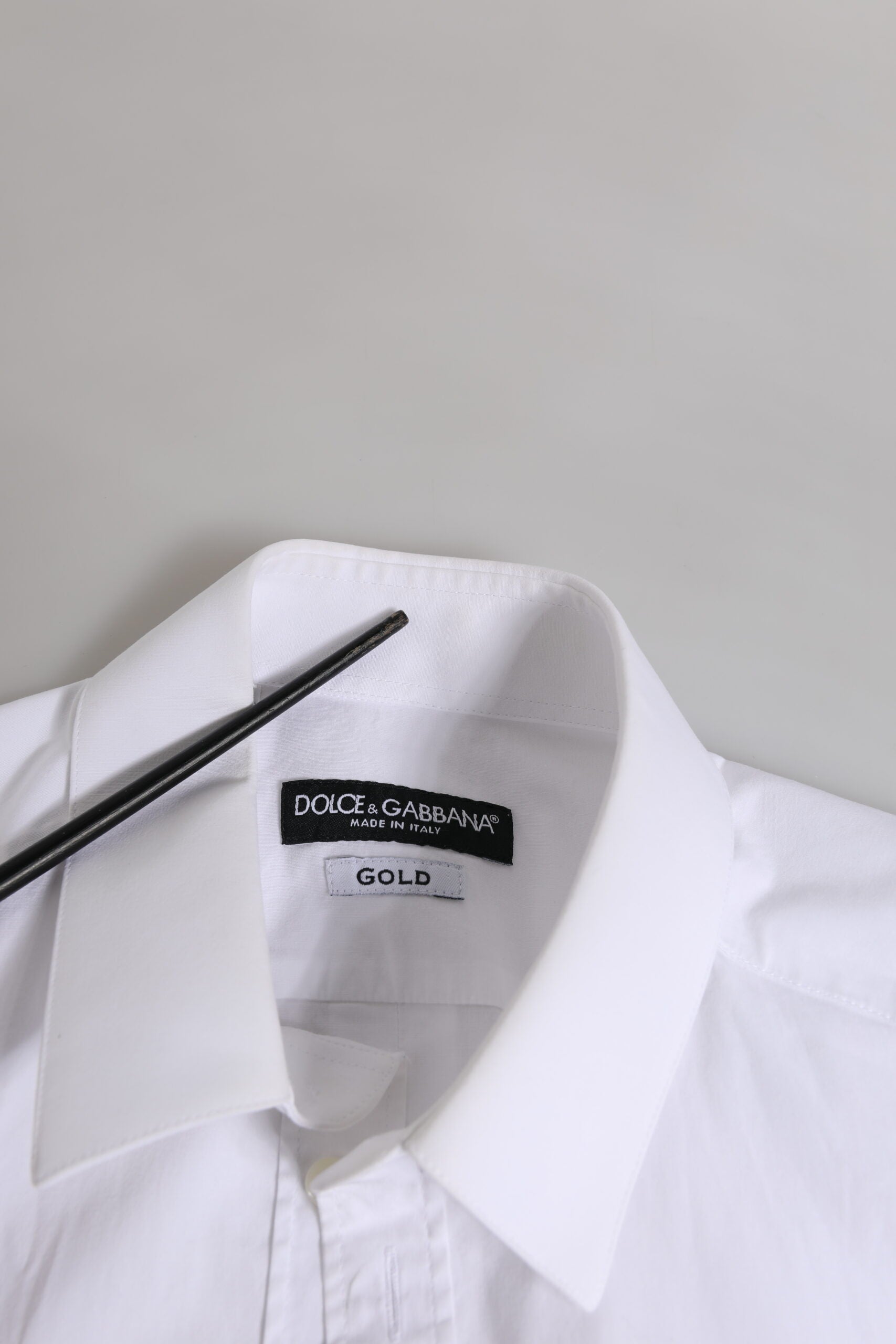 White cotton dress shirt with gold accents, long sleeves, and a collar