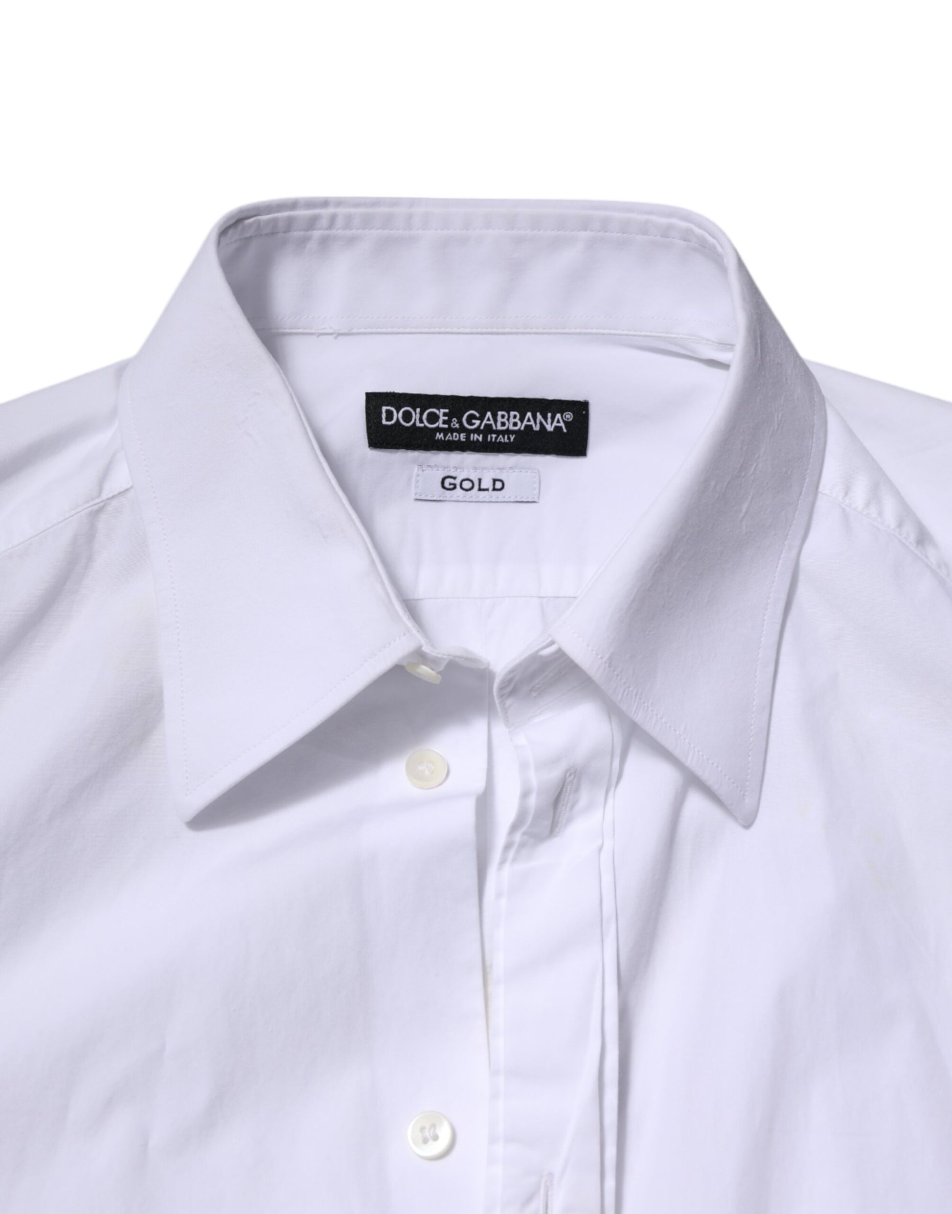 A white cotton dress shirt with long sleeves and a gold label on the collar