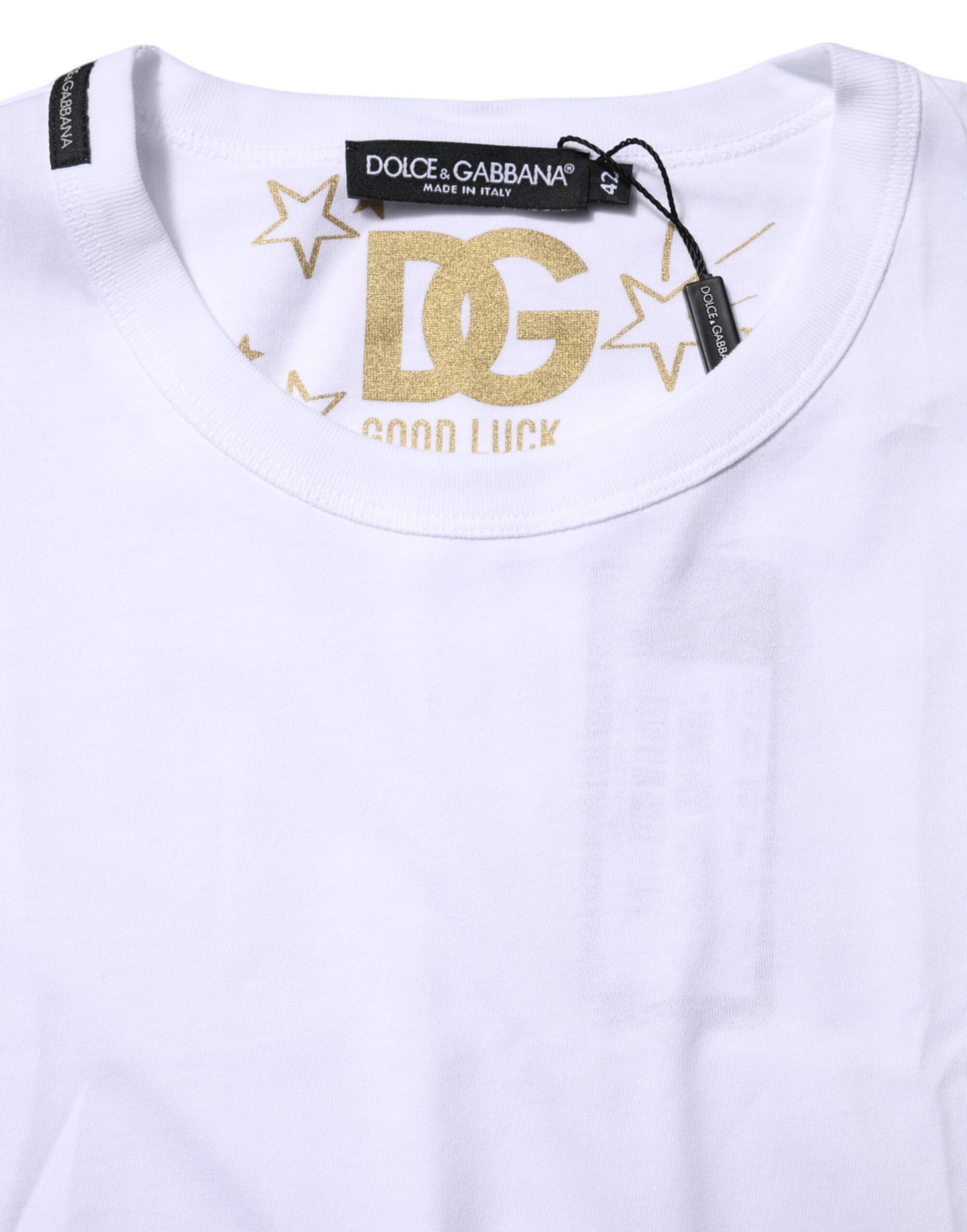 White t-shirt with gold lettering and stars