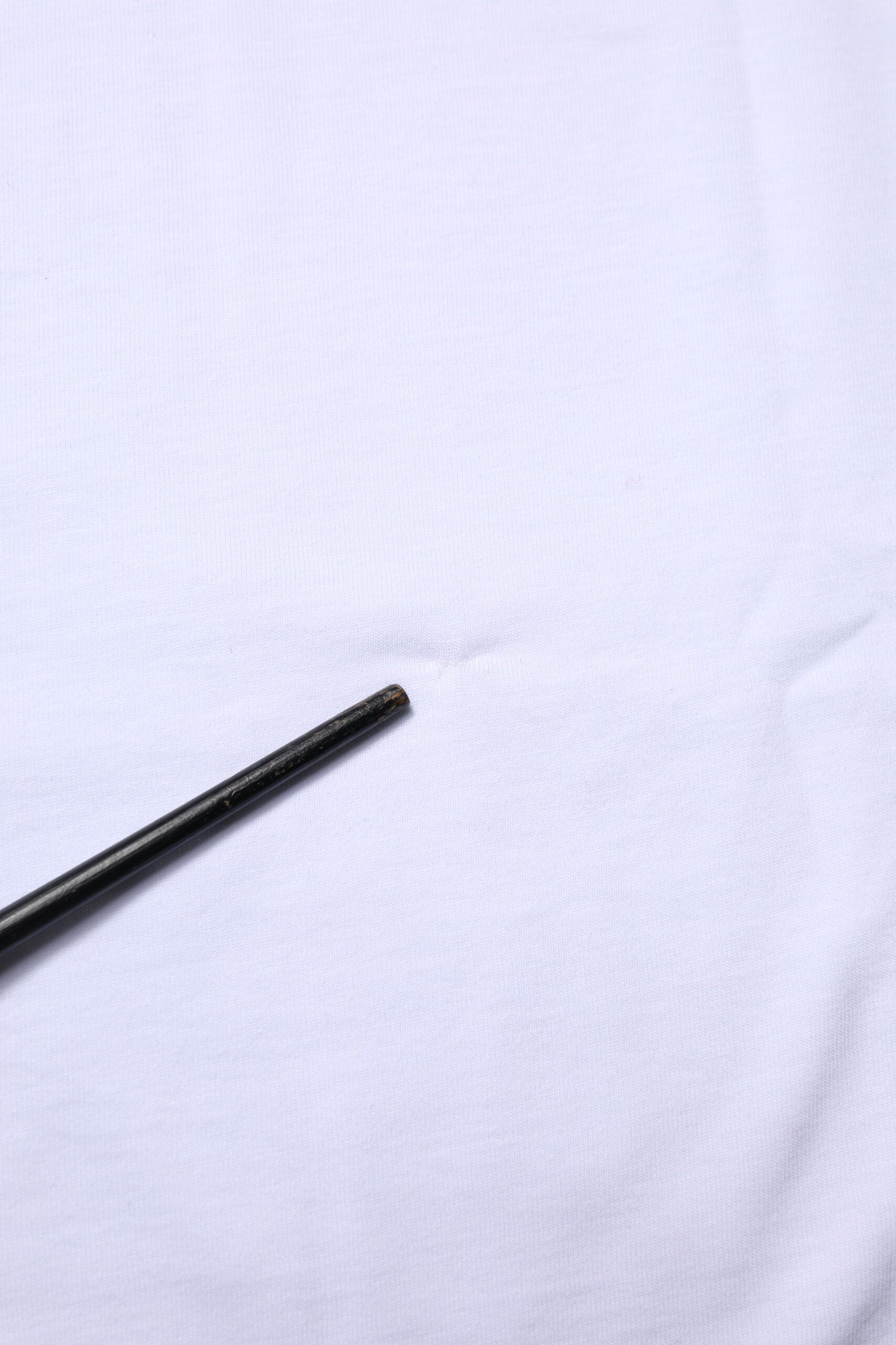 Black pen on white fabric