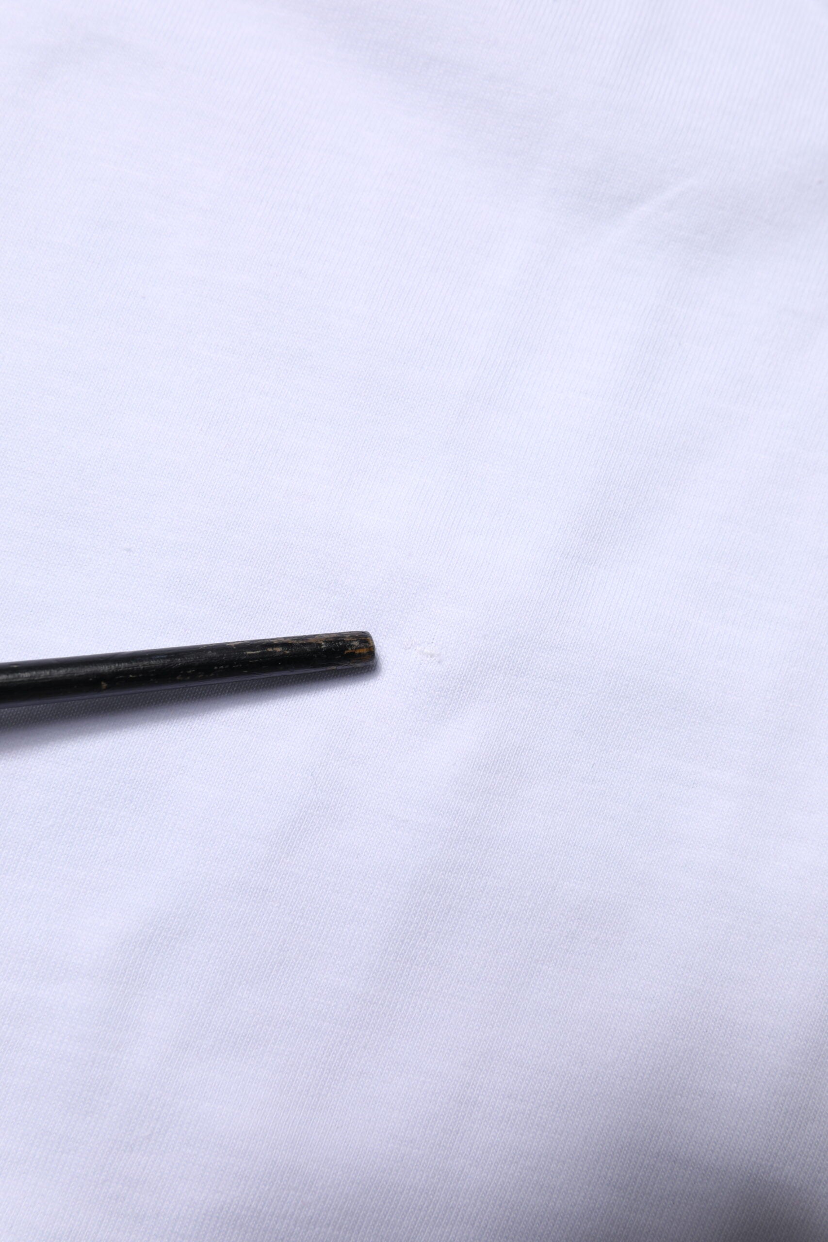 Small black object on white surface