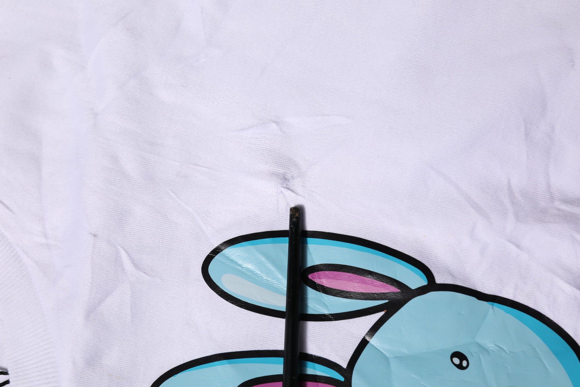 Blue cartoon rabbit on white towel