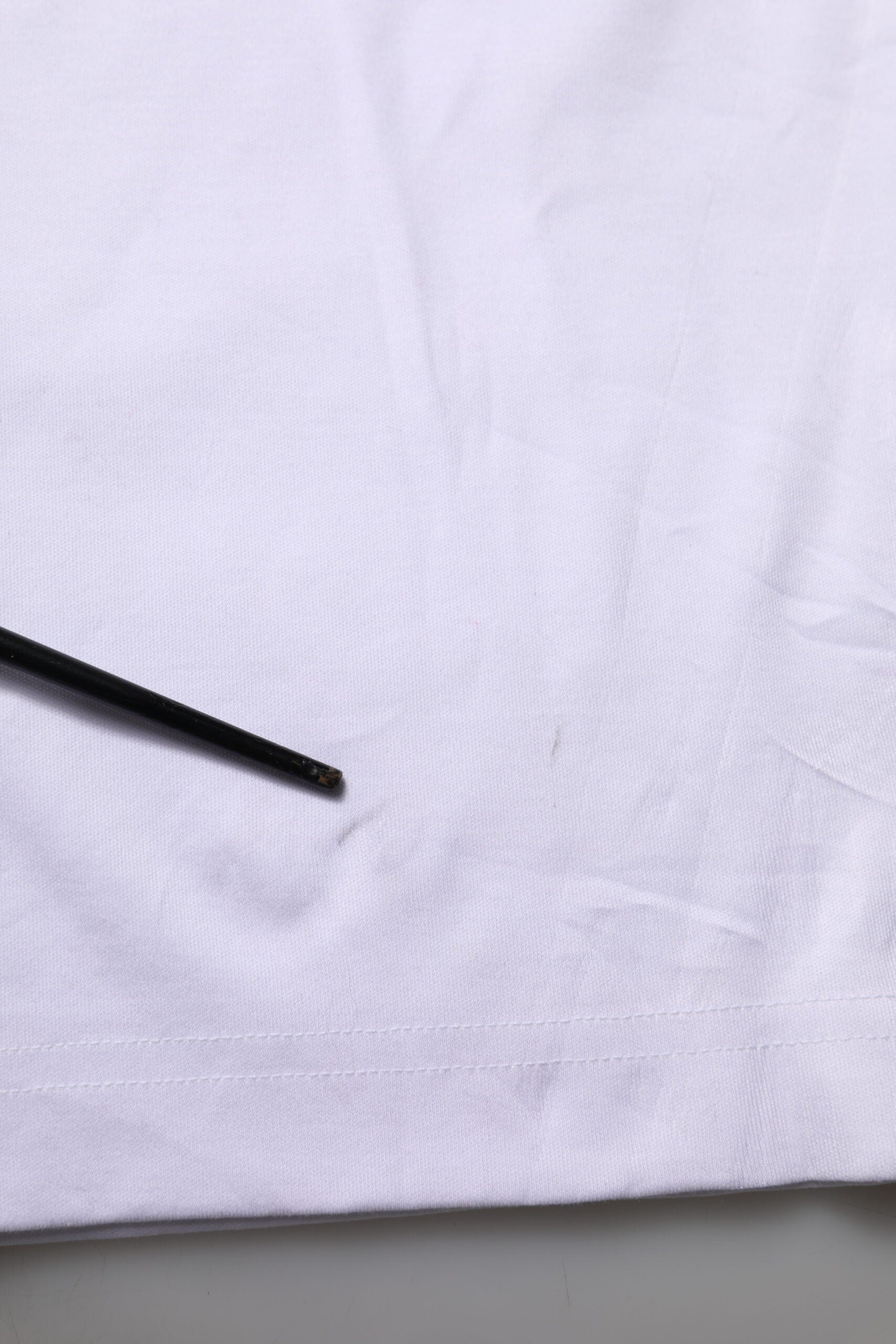 Black pen on white fabric