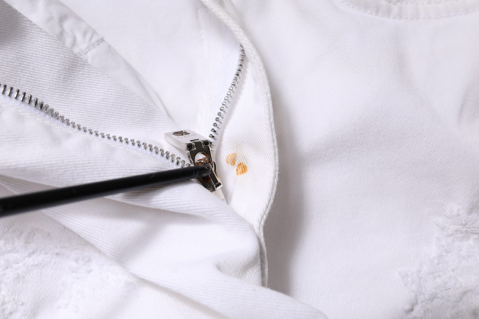 Zipper on white jacket