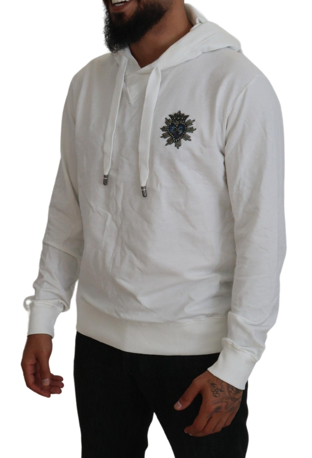 Man wearing white hoodie with emblem on front