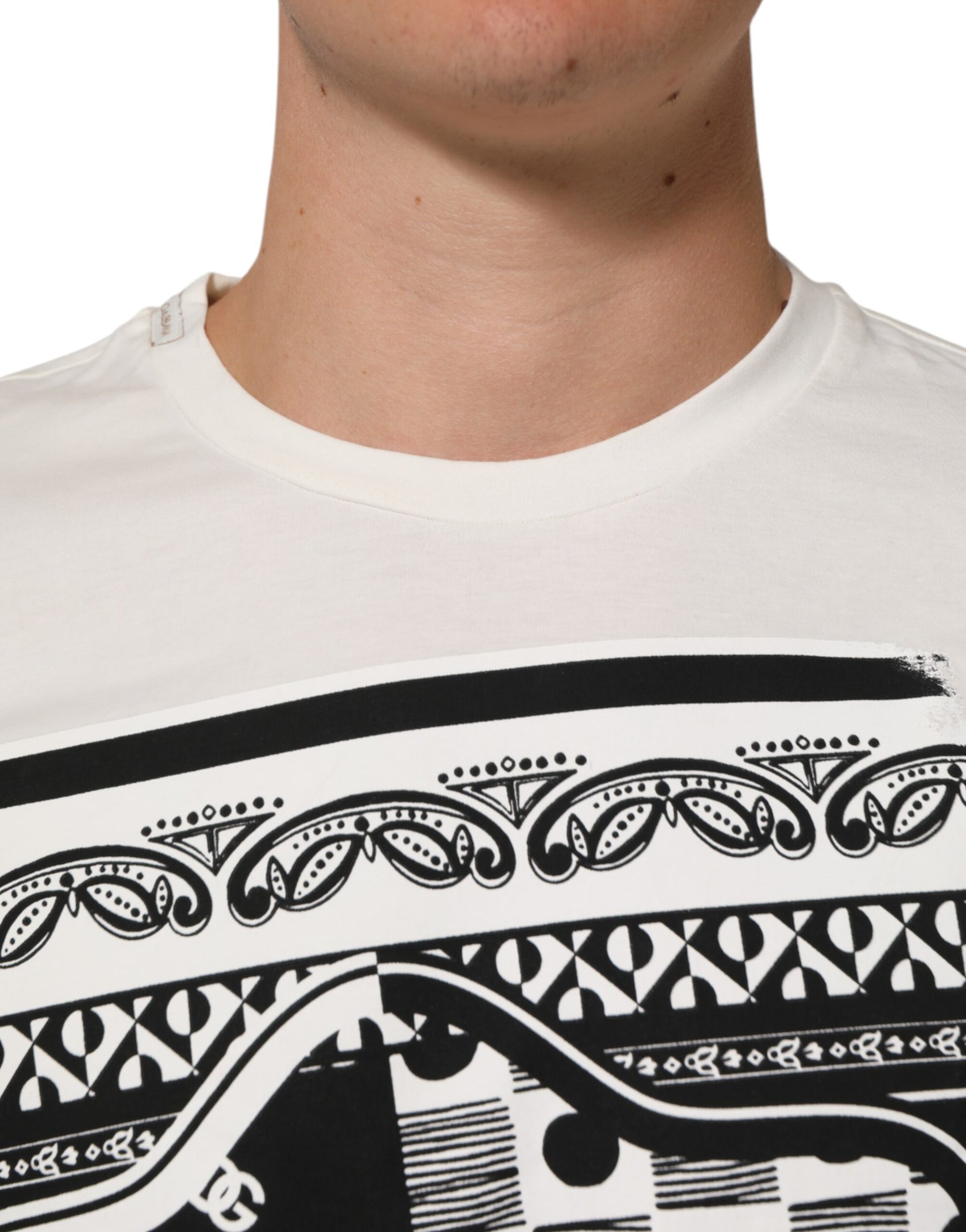 Man wearing white t-shirt with black design on front