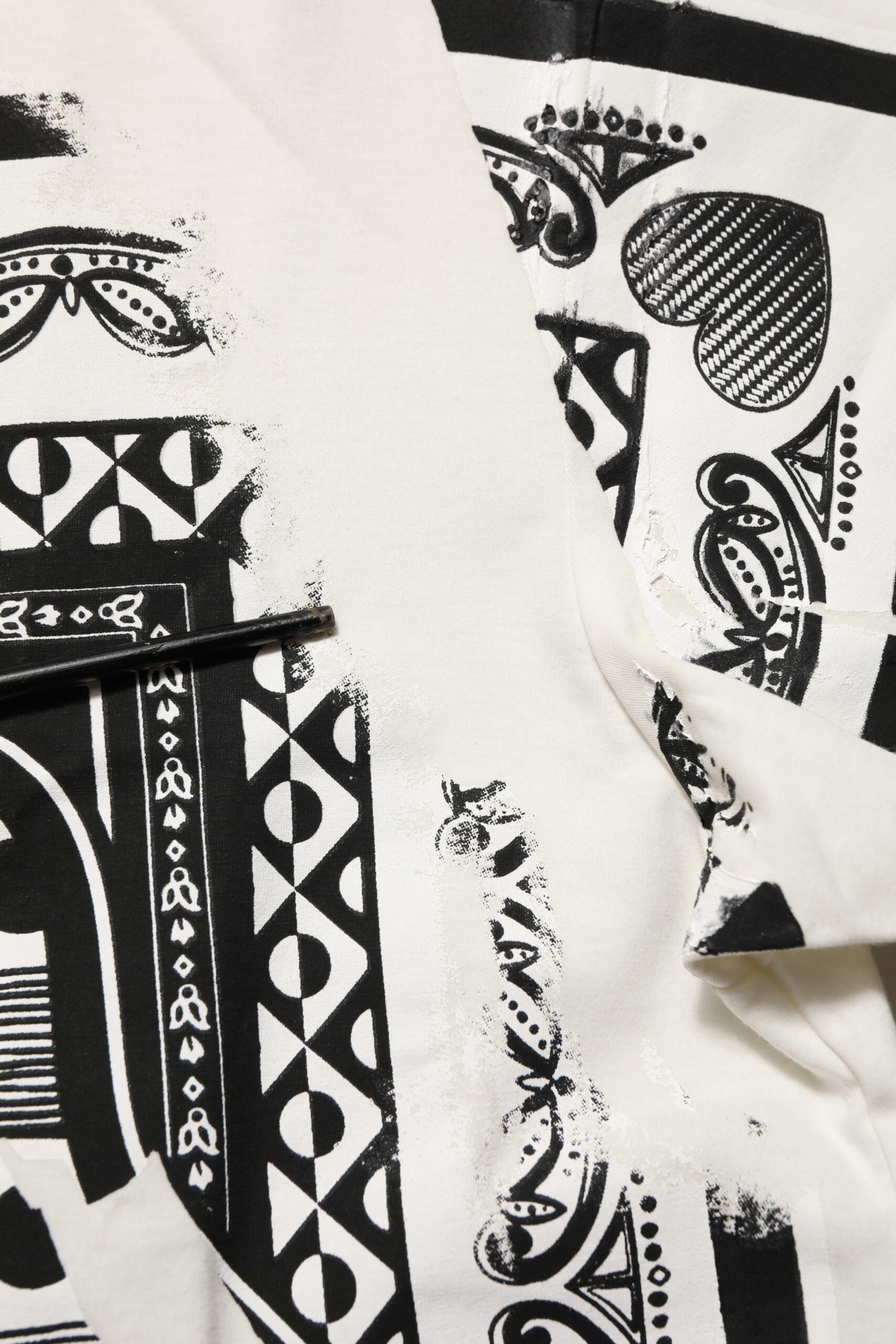 Black and white patterned fabric with torn edges