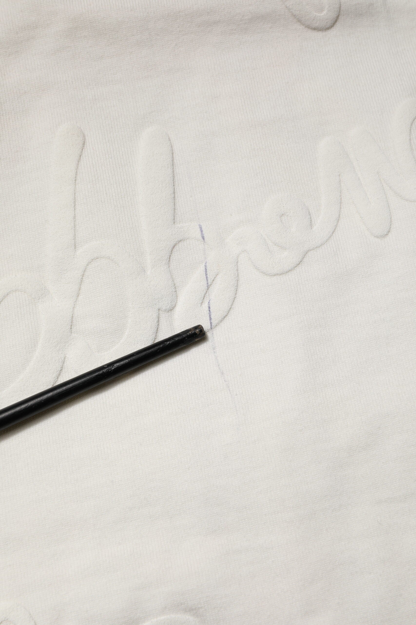 White fabric with black stitching