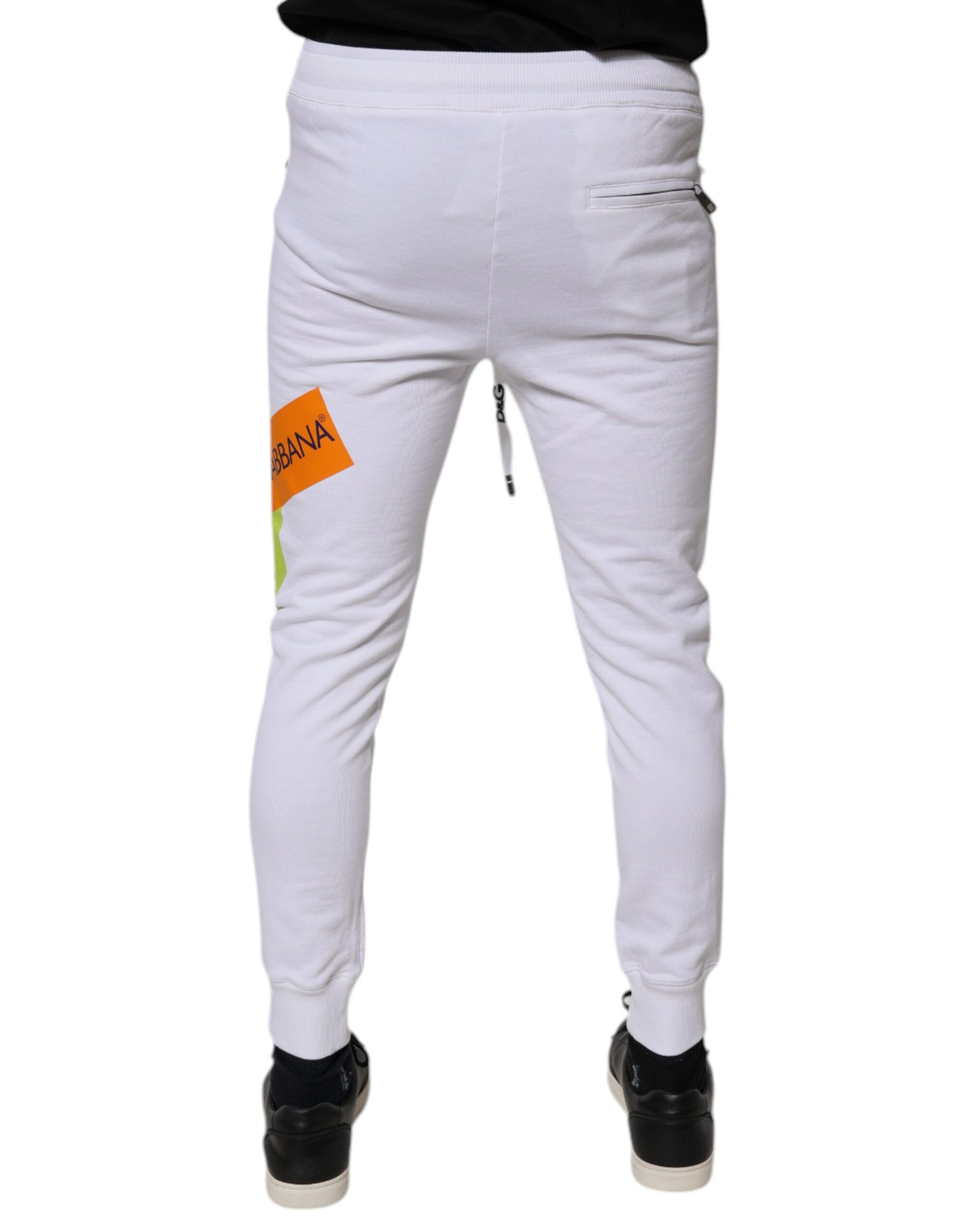 White sweatpants with orange tag on left leg