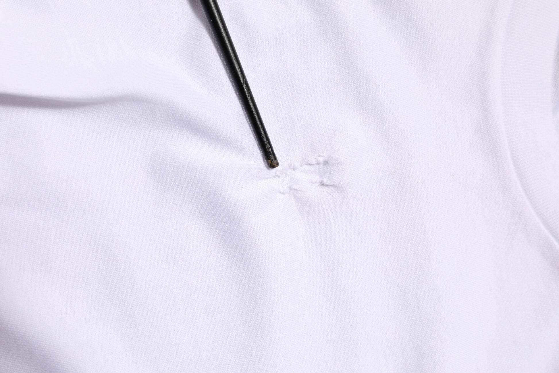 White fabric with small hole on left side