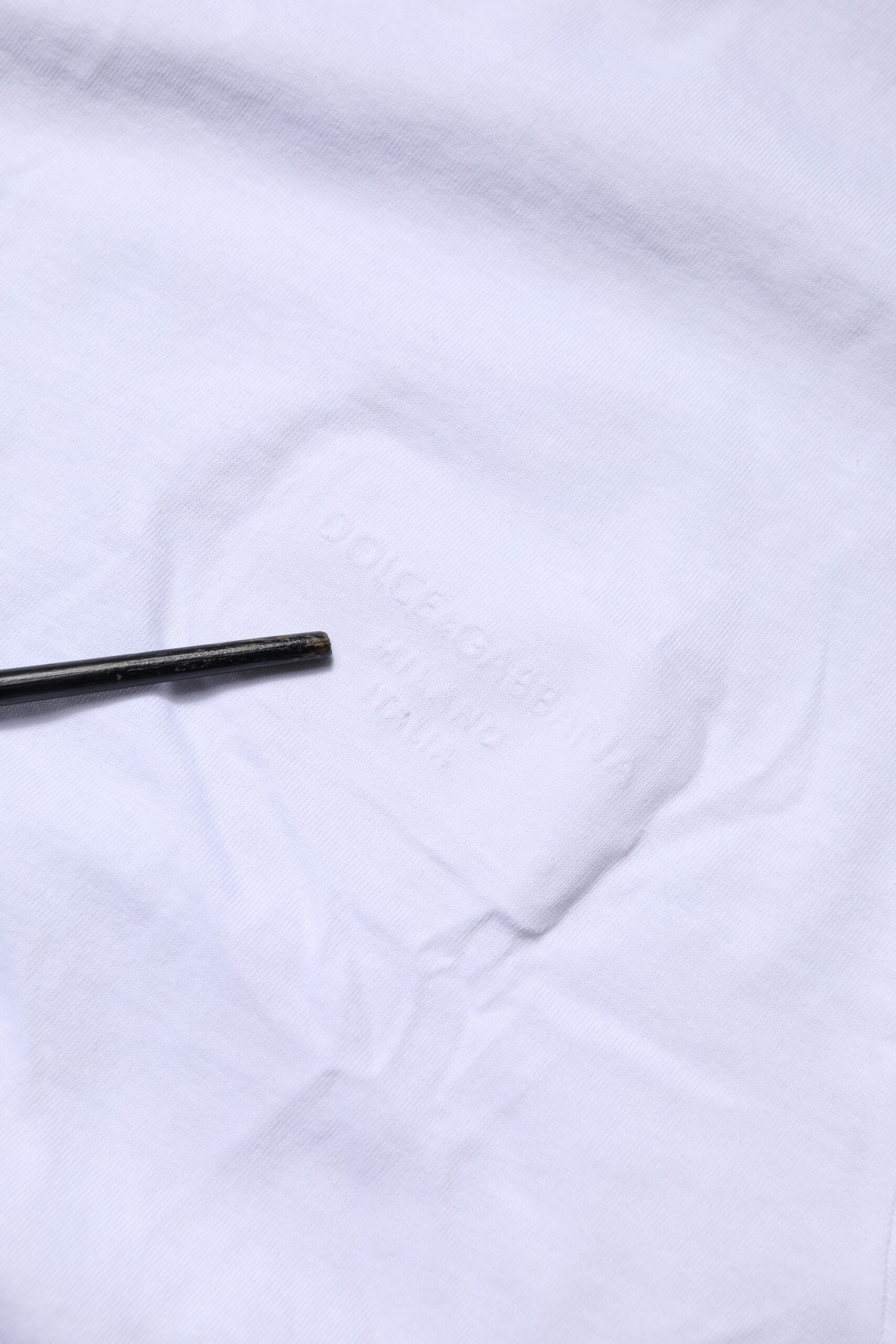 Black marking pen on white fabric