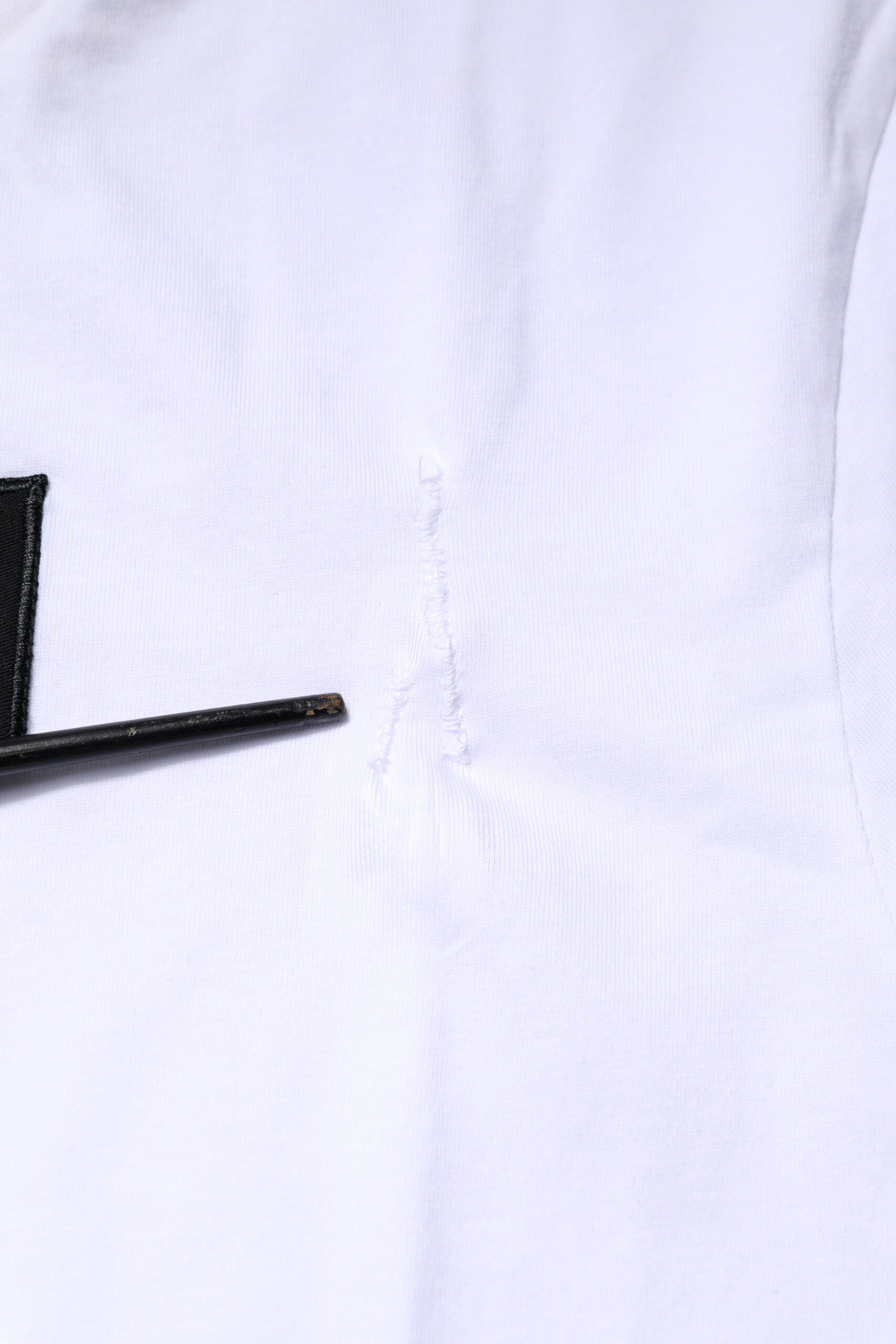 White shirt with black button