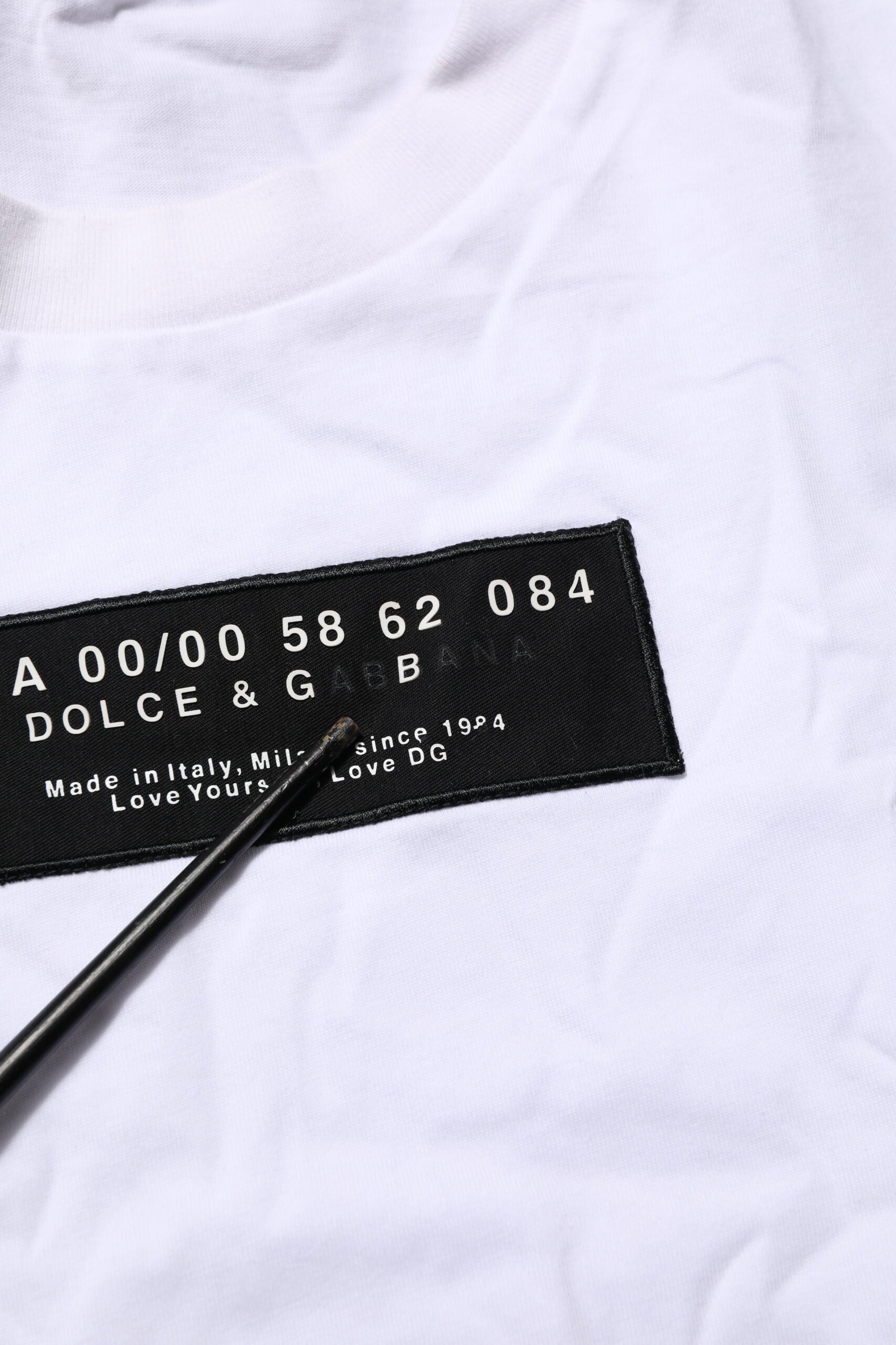 White t-shirt with black lettering and numbering on front