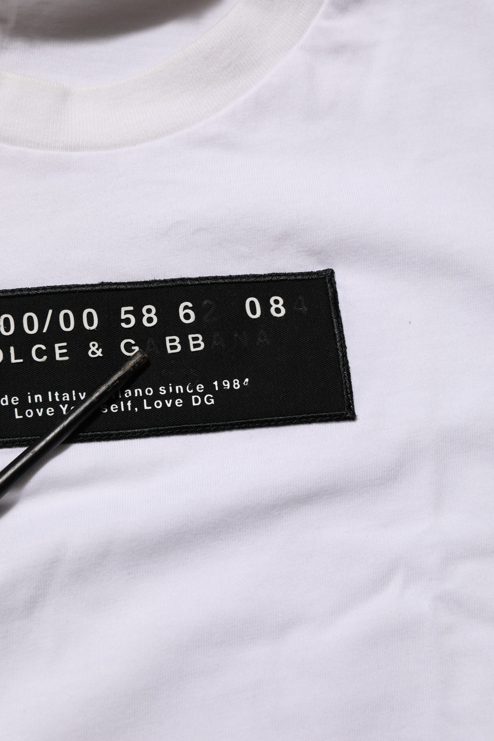 White t-shirt with black lettering and numbers on front