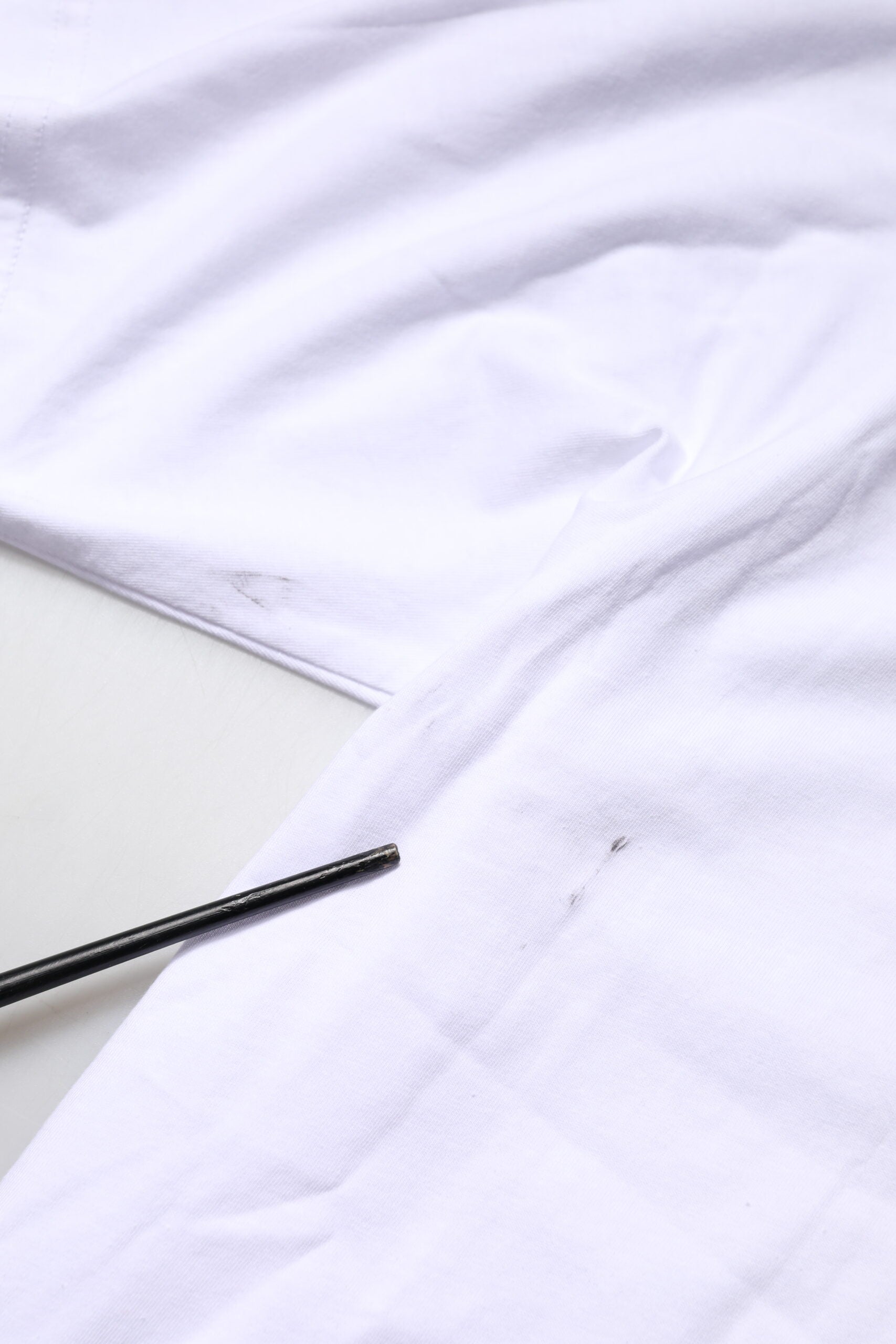 White cloth on table with black markings