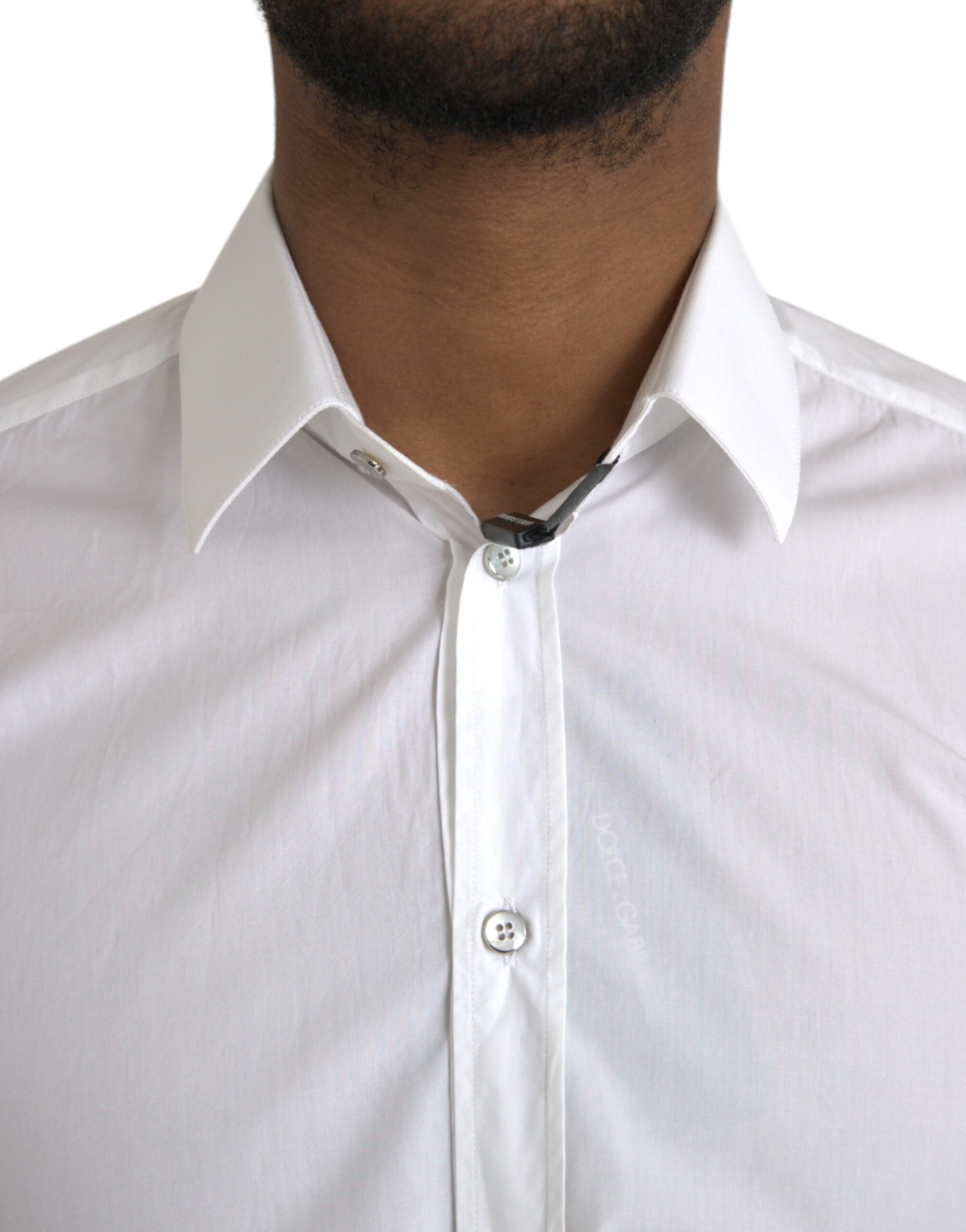 A white cotton long sleeve dress shirt with a collar and buttons