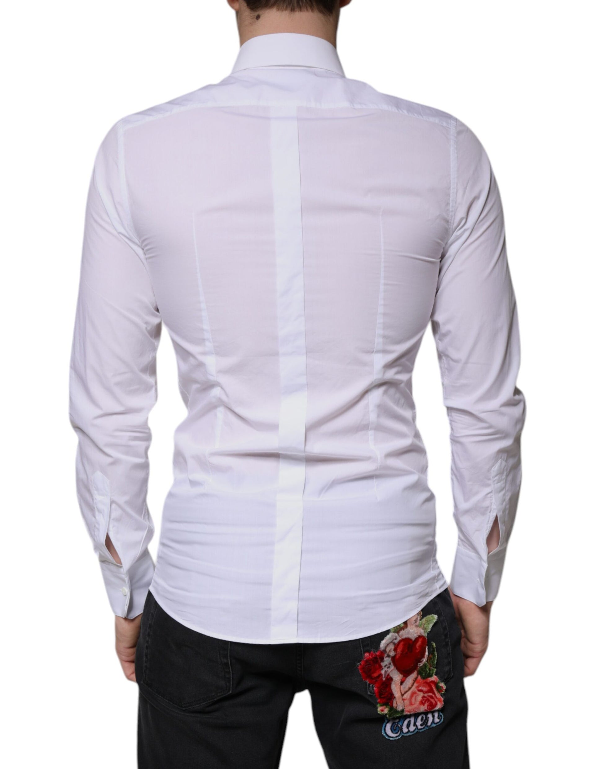A mannequin wearing a white cotton long sleeve shirt with gold accents