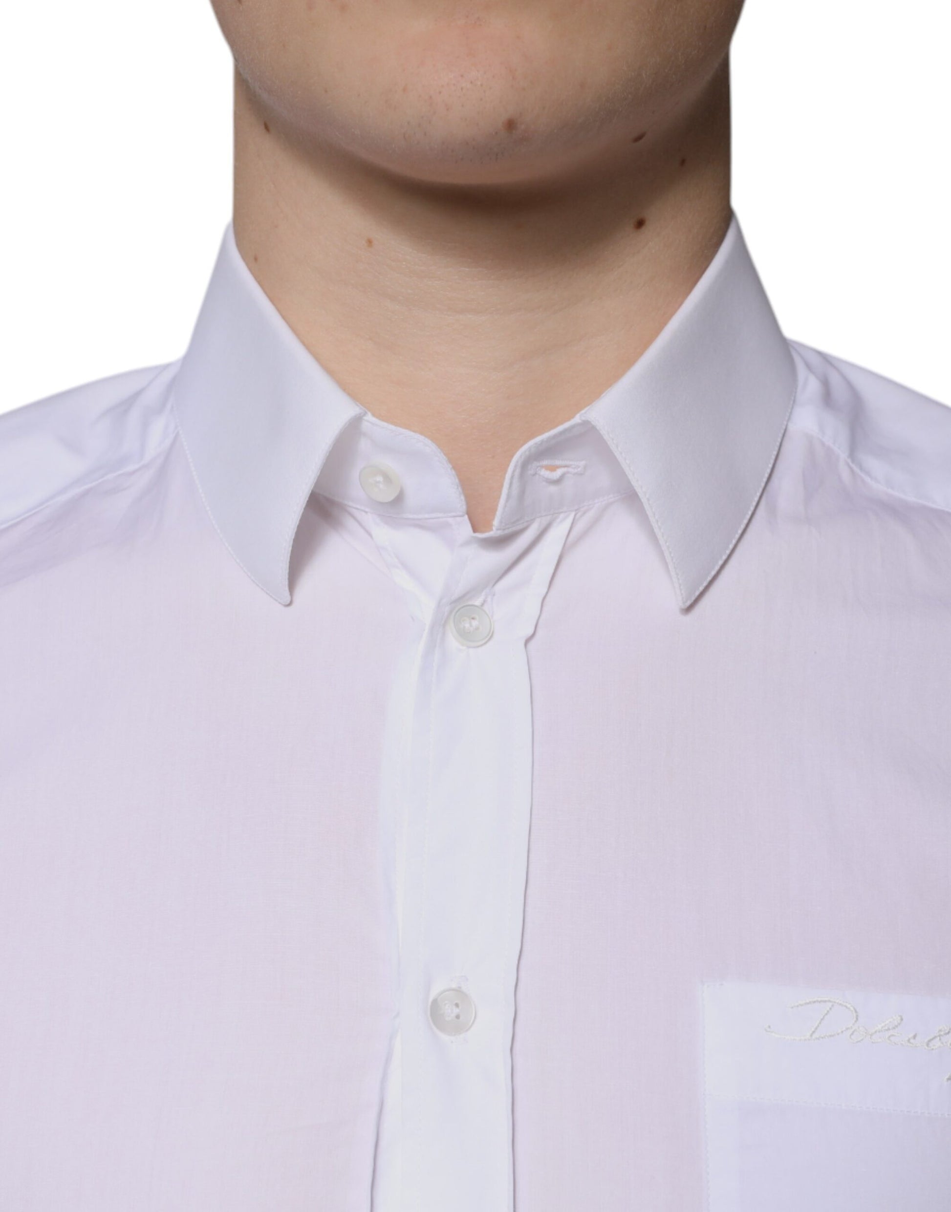 A long sleeved white cotton dress shirt with gold buttons and a collar