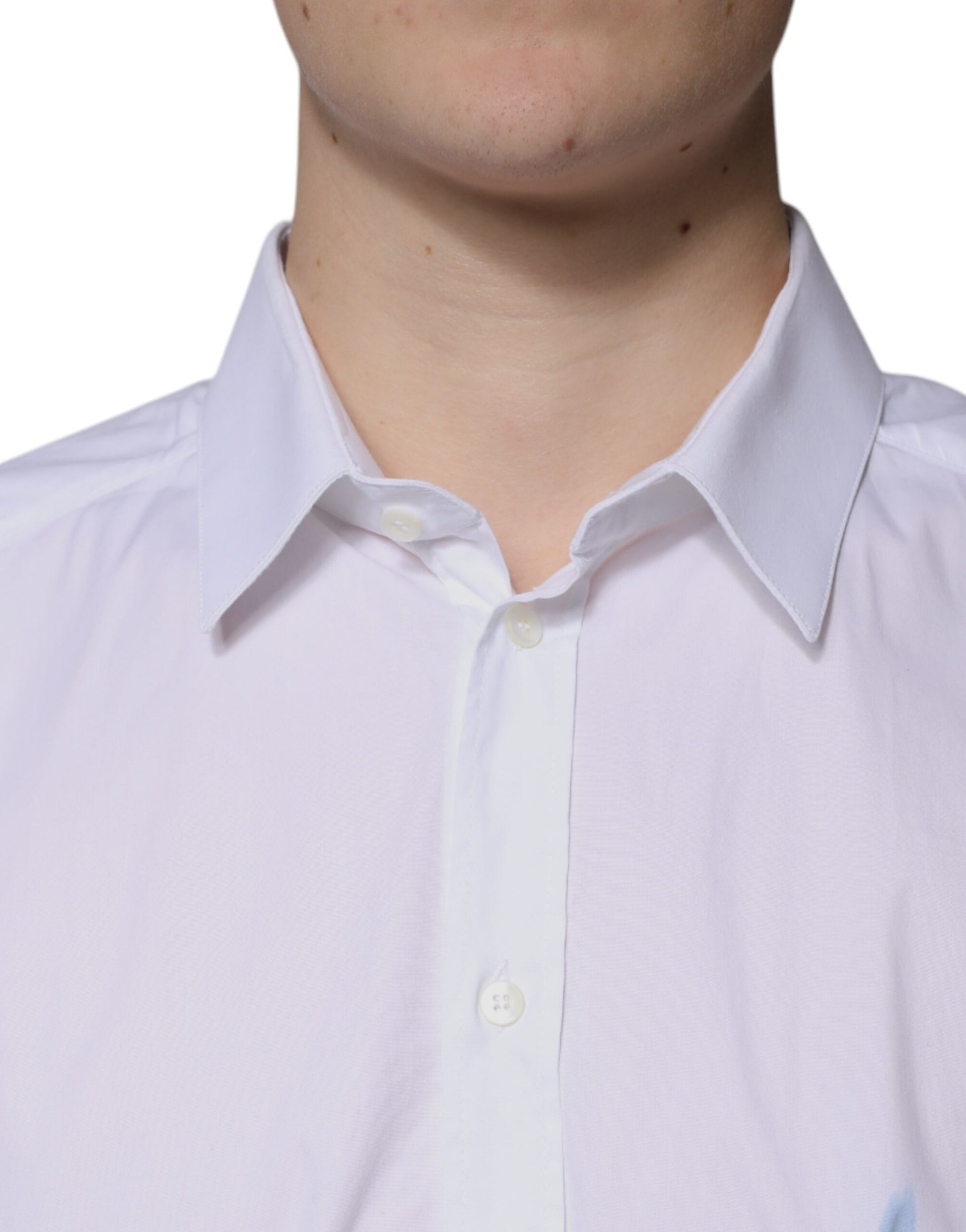 A long sleeve white cotton dress shirt with a gold collar and buttons