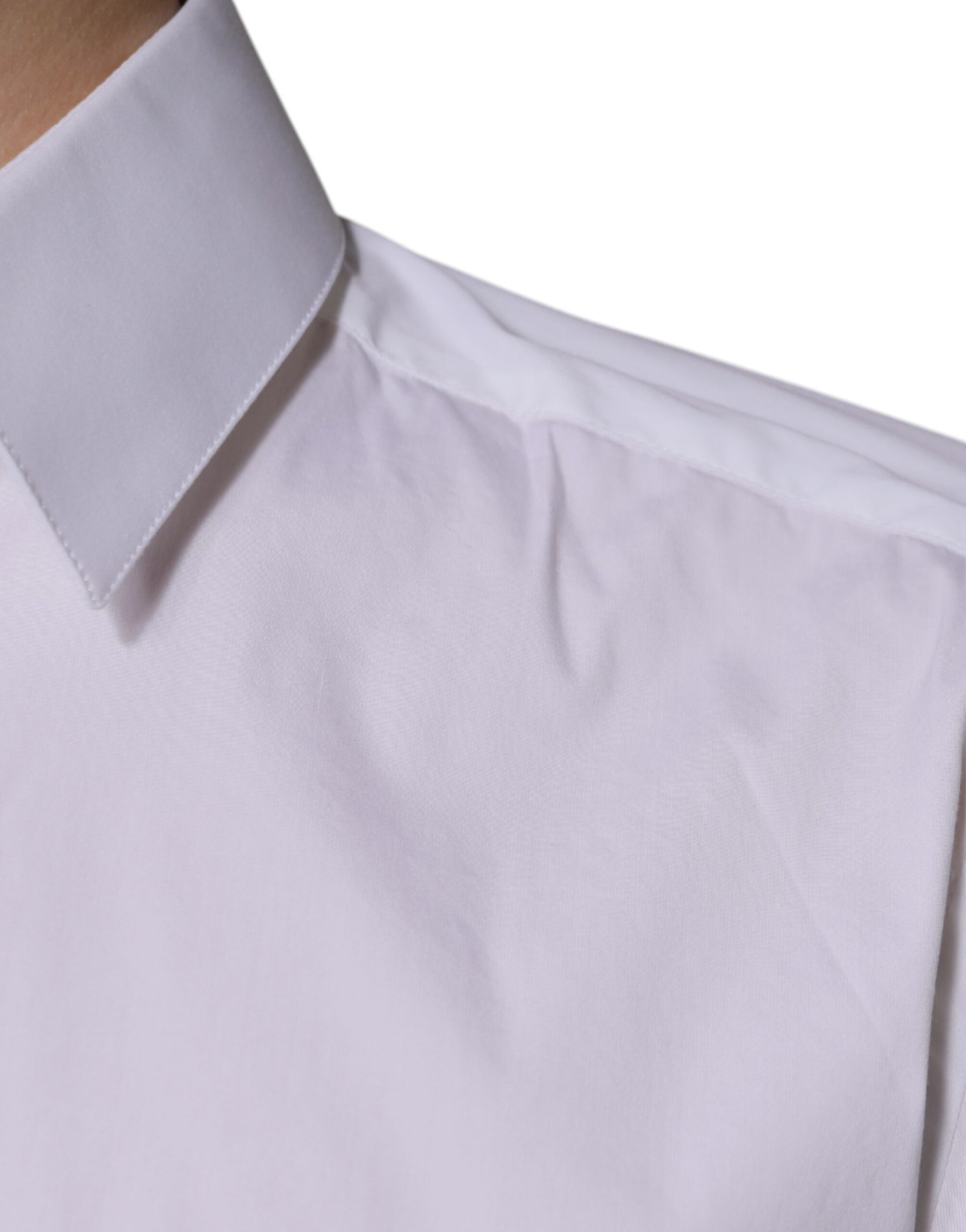 A white cotton dress shirt with long sleeves and a collar, featuring a gold design