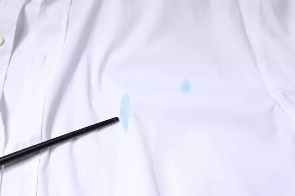 A white cotton long sleeve dress shirt with a gold design on the front