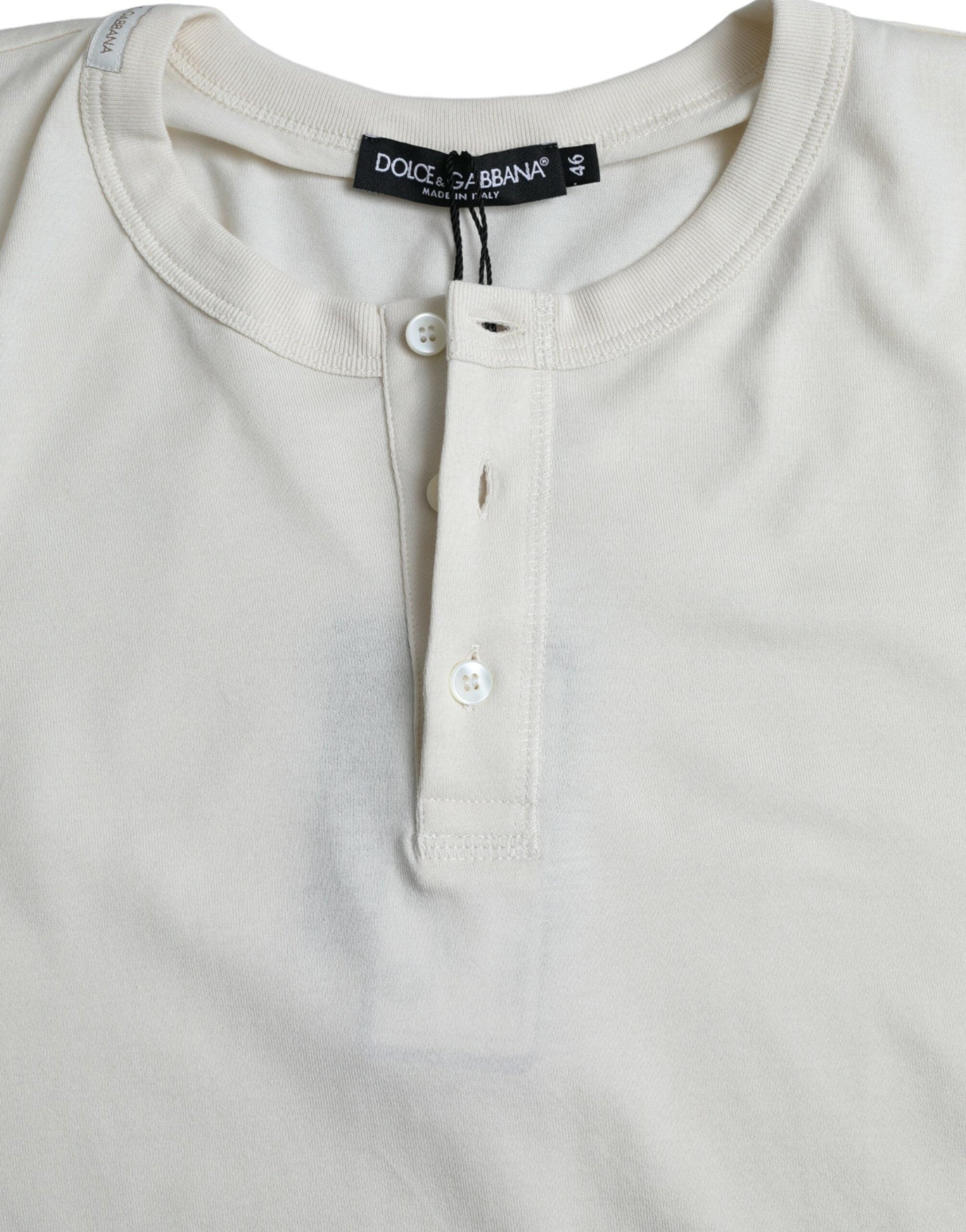 A long sleeve t-shirt with a buttoned front and a label on the collar