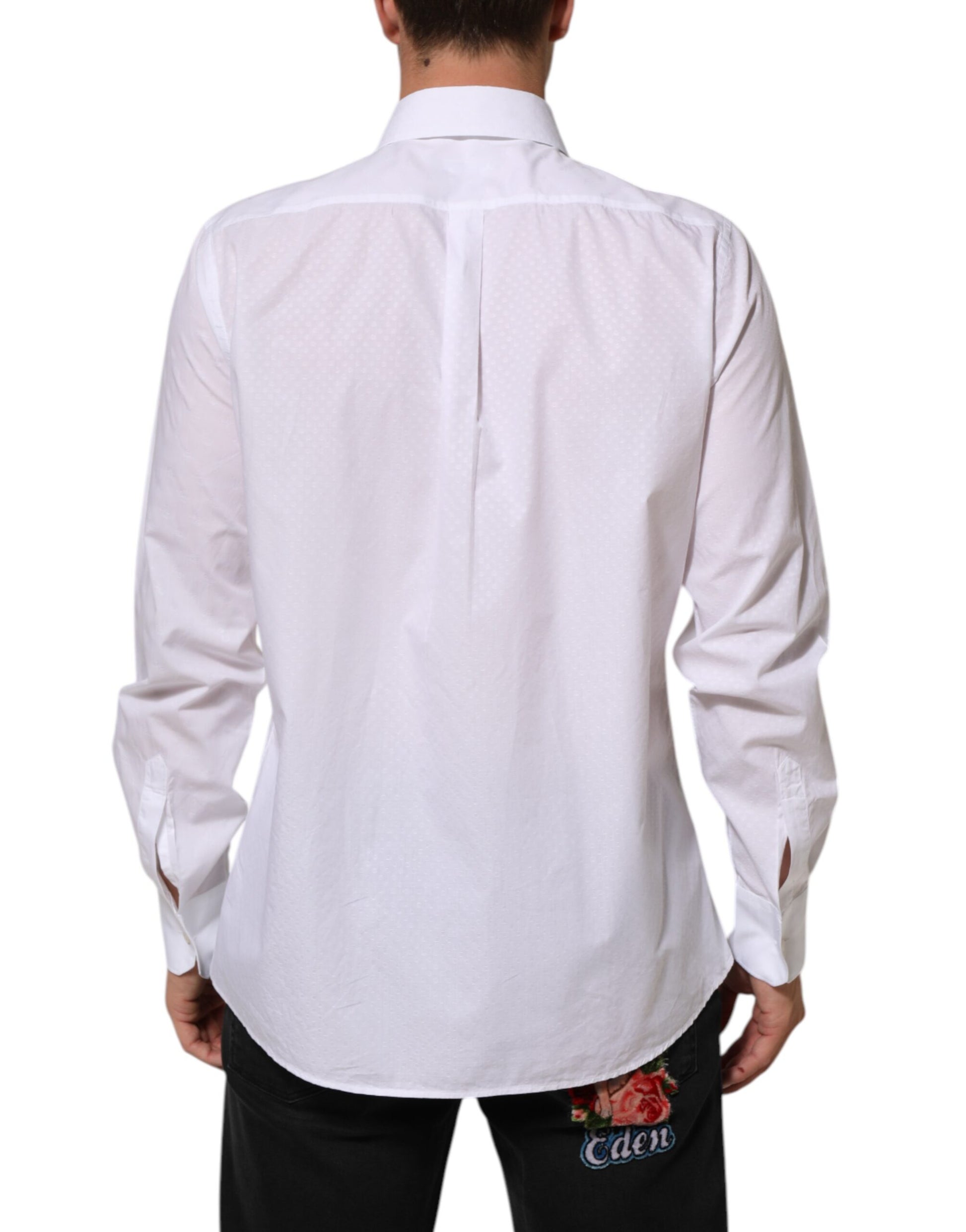 A white cotton shirt with a bib front and floral embroidery on the back