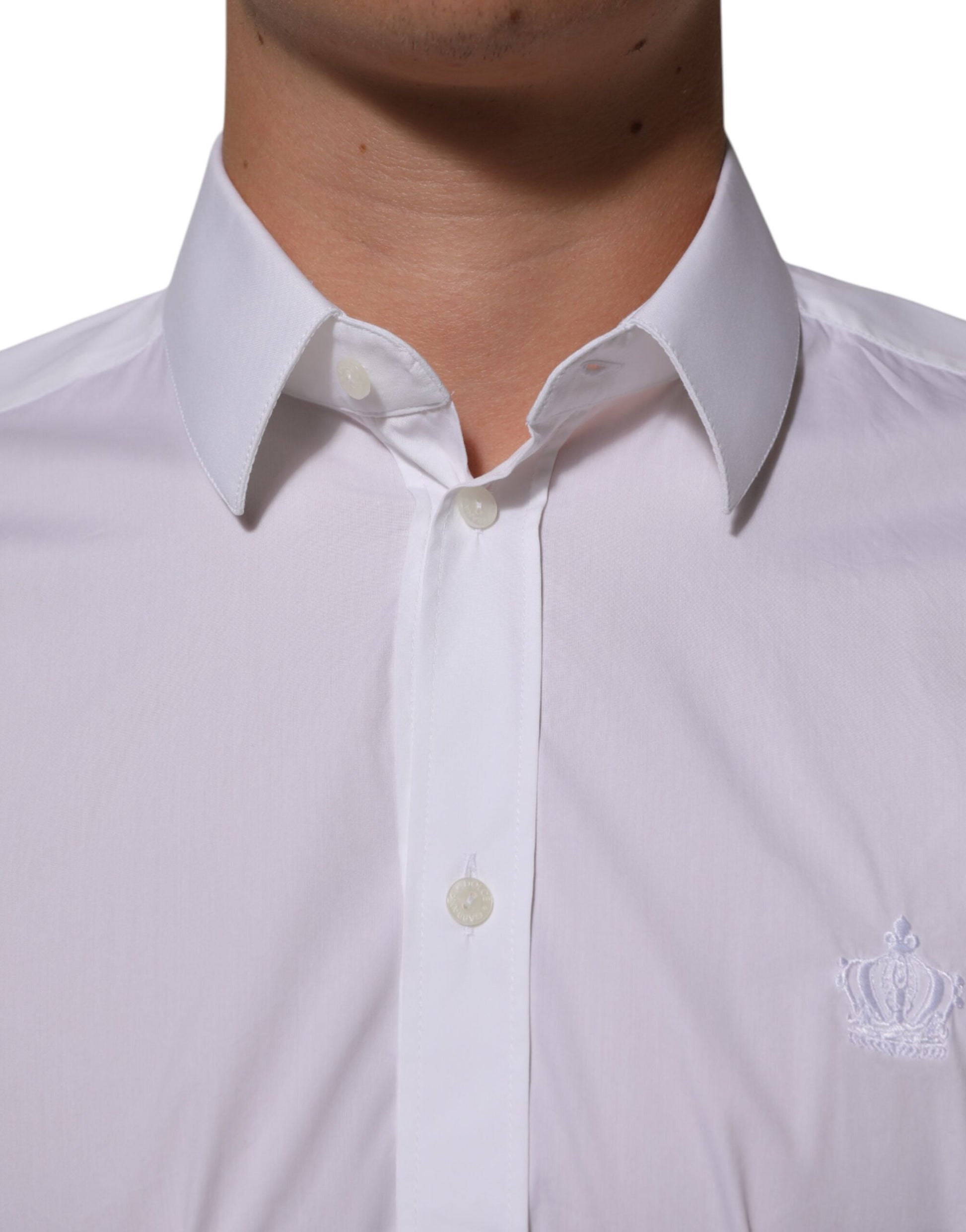 A white cotton dress shirt with a collar and buttons, featuring the Dolce & Gabbana logo