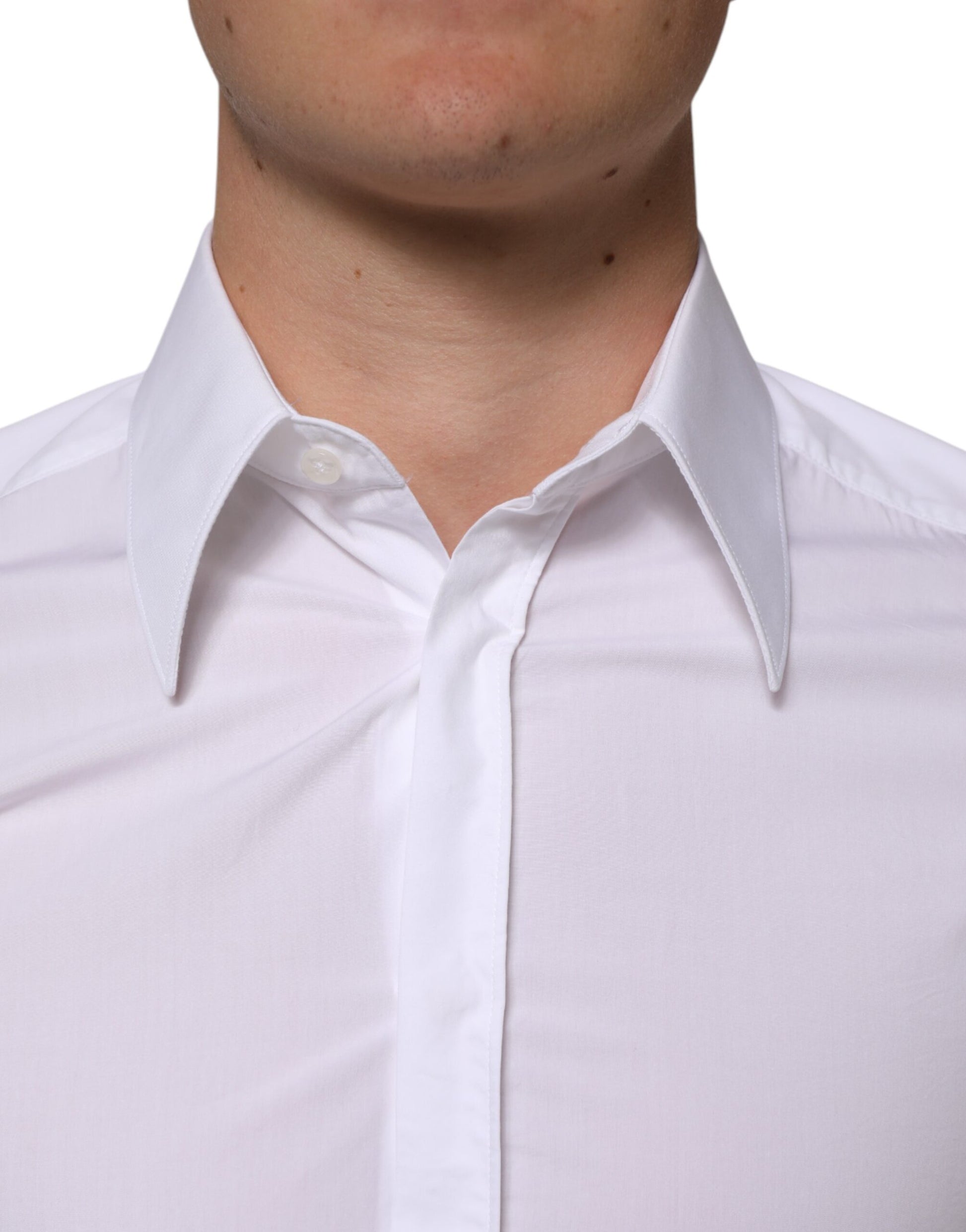 A white cotton dress shirt with long sleeves, featuring a collar and button-up front