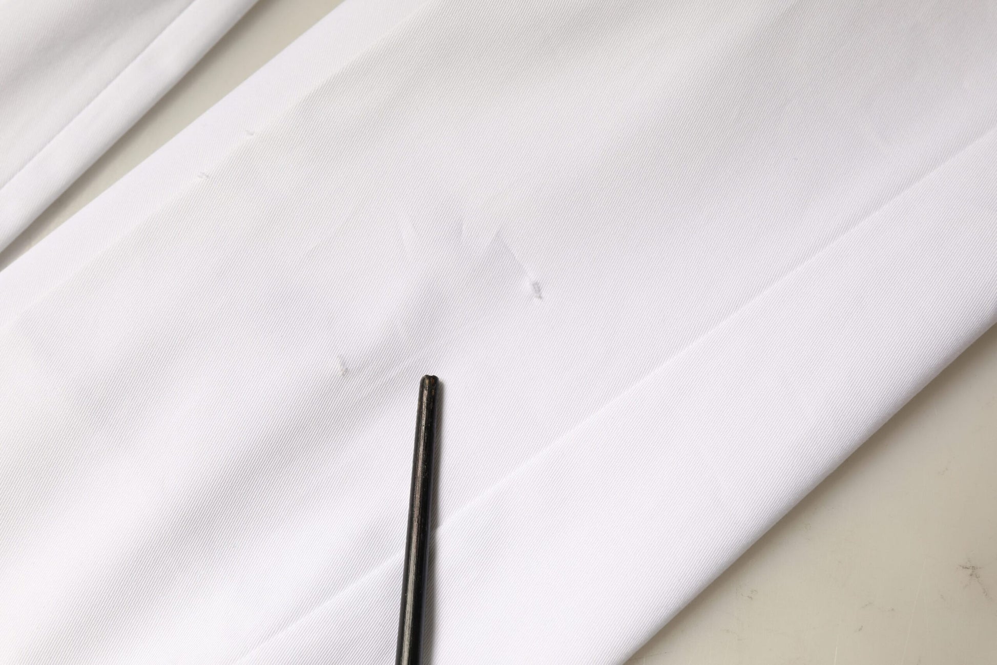 Black pen on white fabric