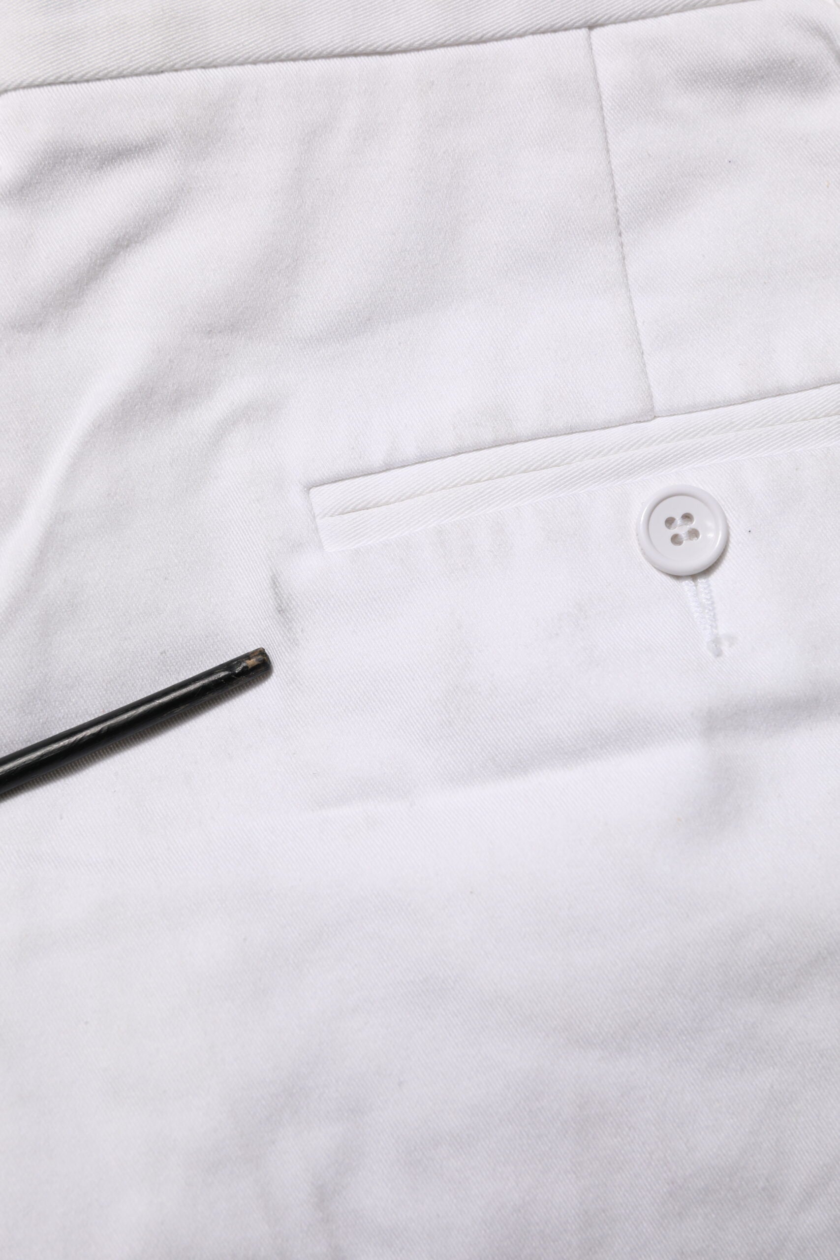 White button on pocket of white shirt