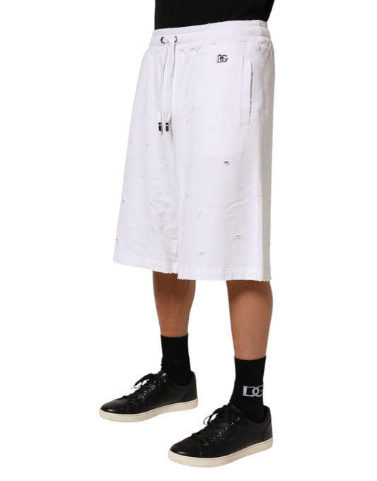 Man wearing white shorts and black shoes