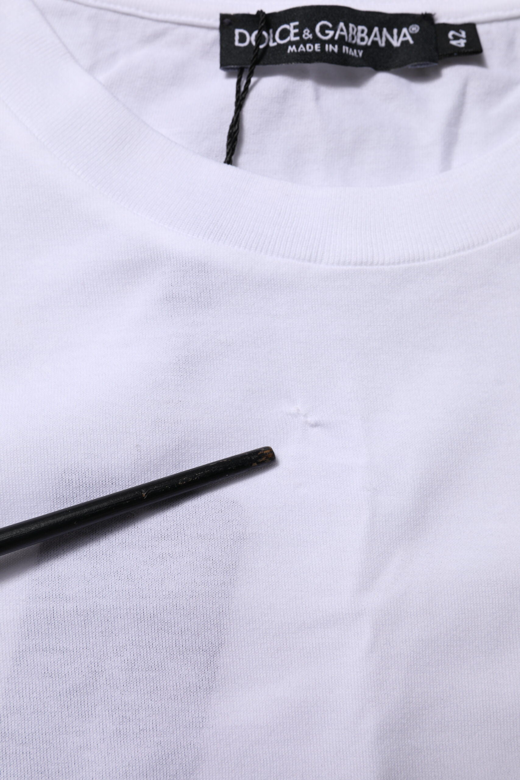White t-shirt on hanger with black label